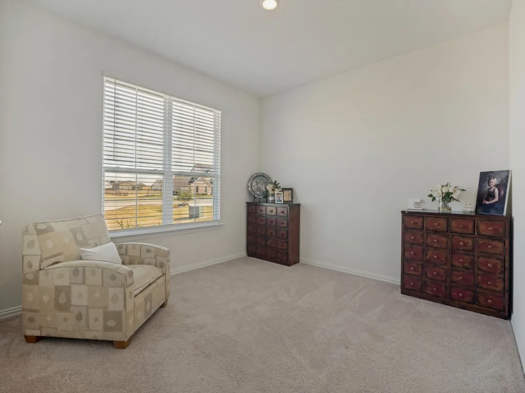 Carpeted flooring, white interior walls, and a recessed ceiling light