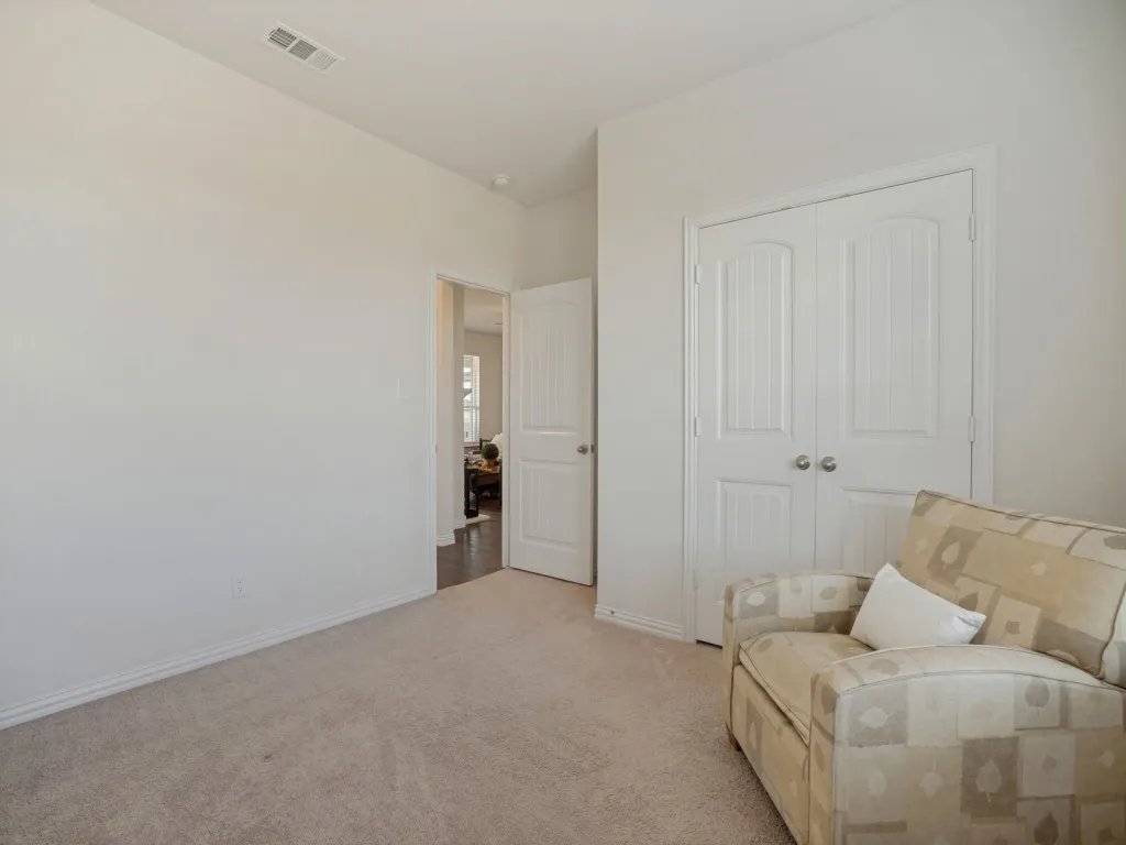 Neutral paint palette with carpeted flooring and white trim