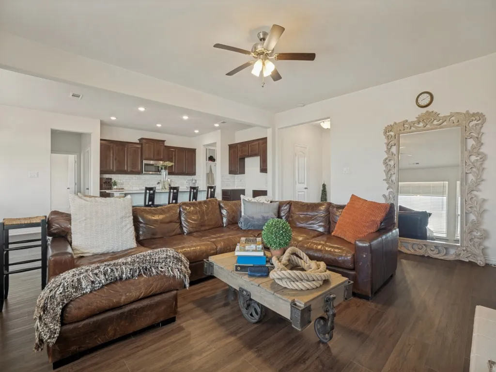 Open-concept living area featuring wood-finish flooring, recessed lighting, and a ceiling fan