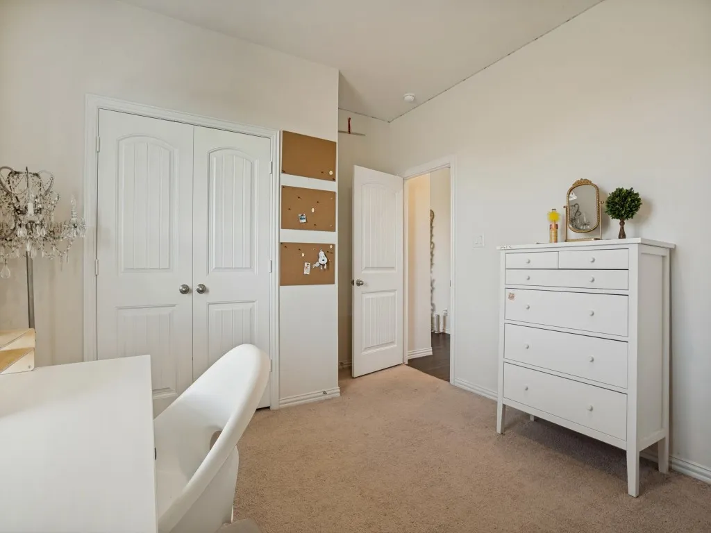 Neutral wall paint, carpet flooring, and white interior doors