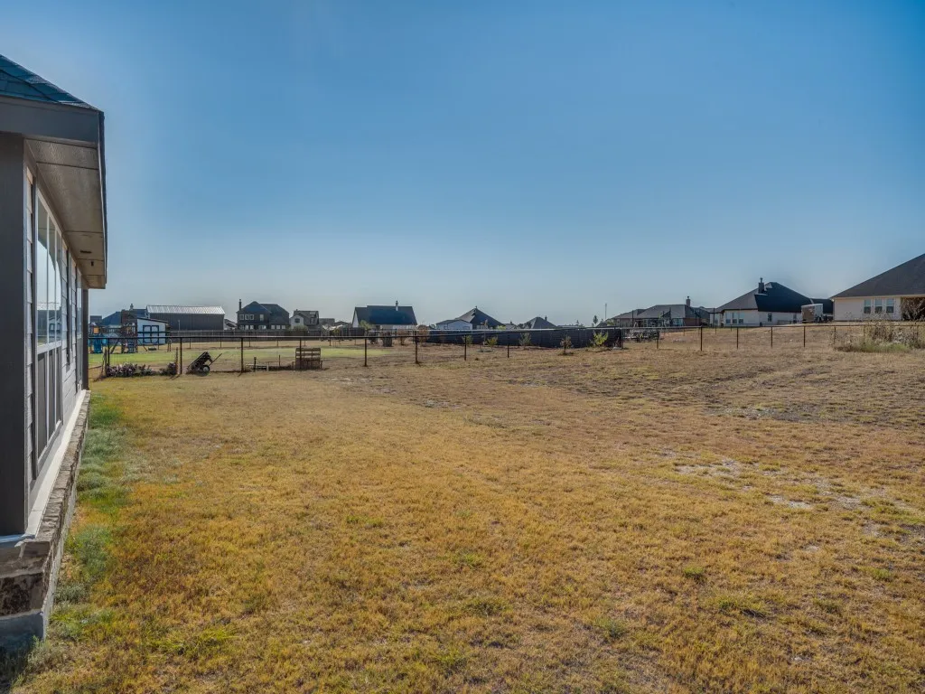 Expansive undeveloped land area with perimeter fencing
