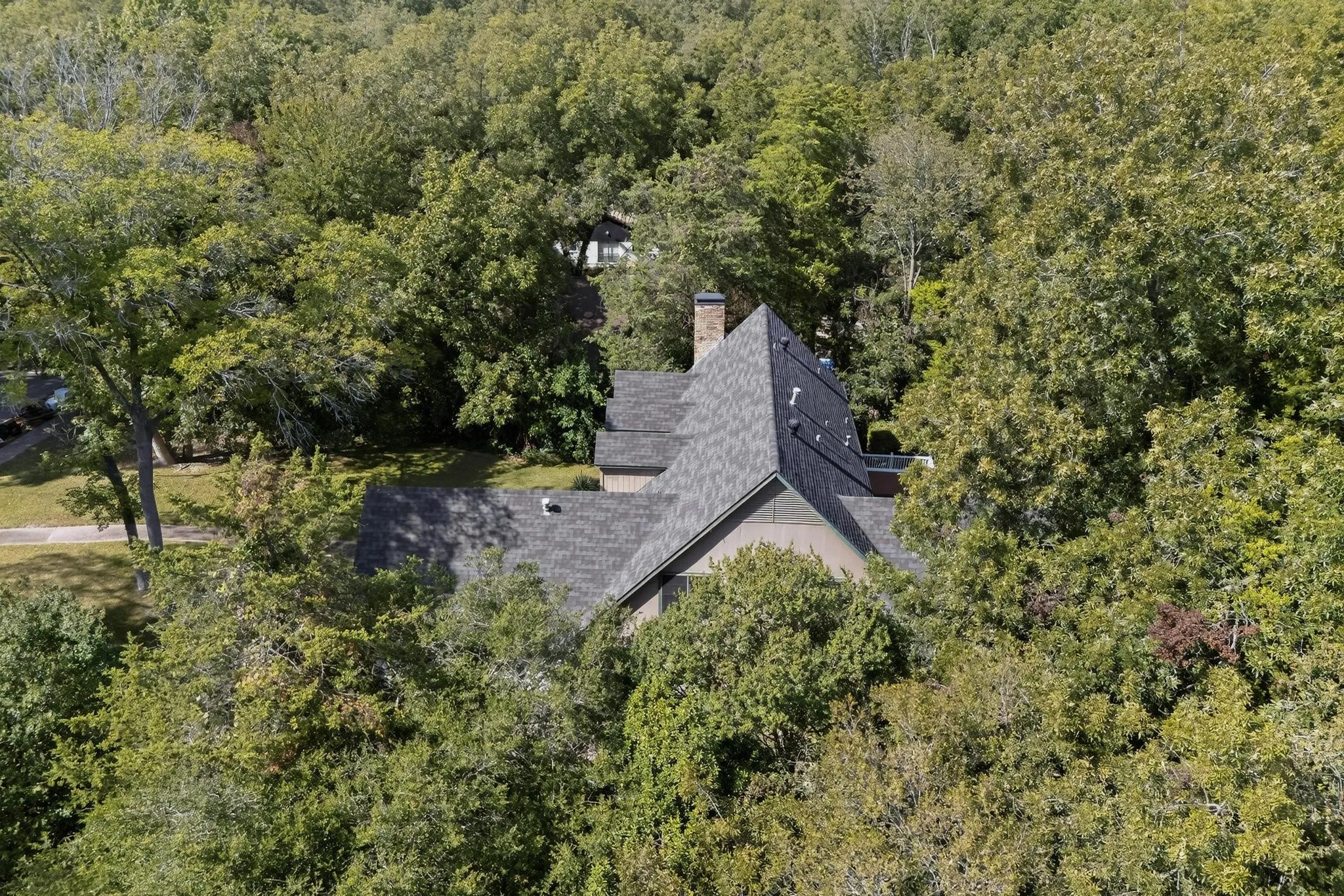 View of subject property with a heavily wooded area