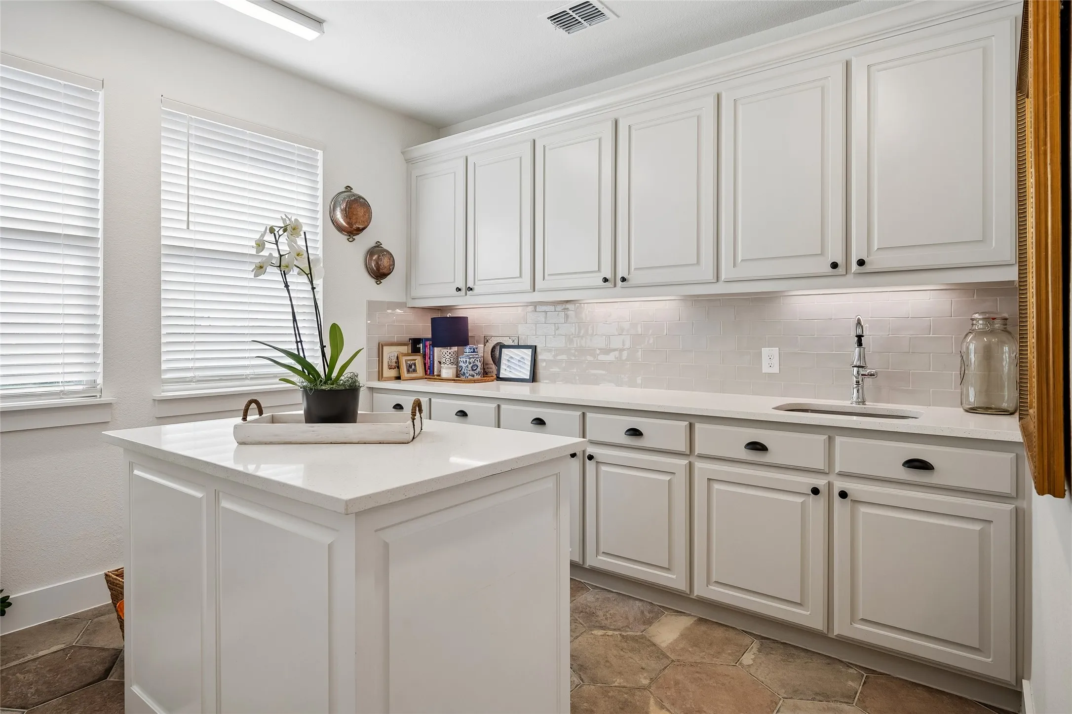 This flex room has served as a catering prep kitchen with its sink.  Accent lighting and plenty of storage space!