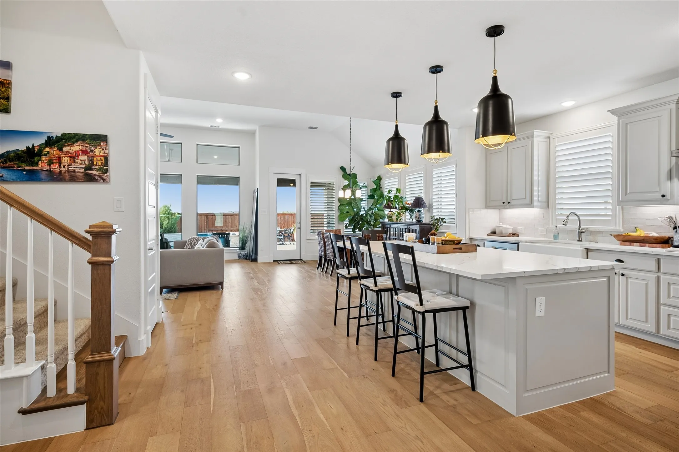 Pendant lights accent island with breakfast bar.