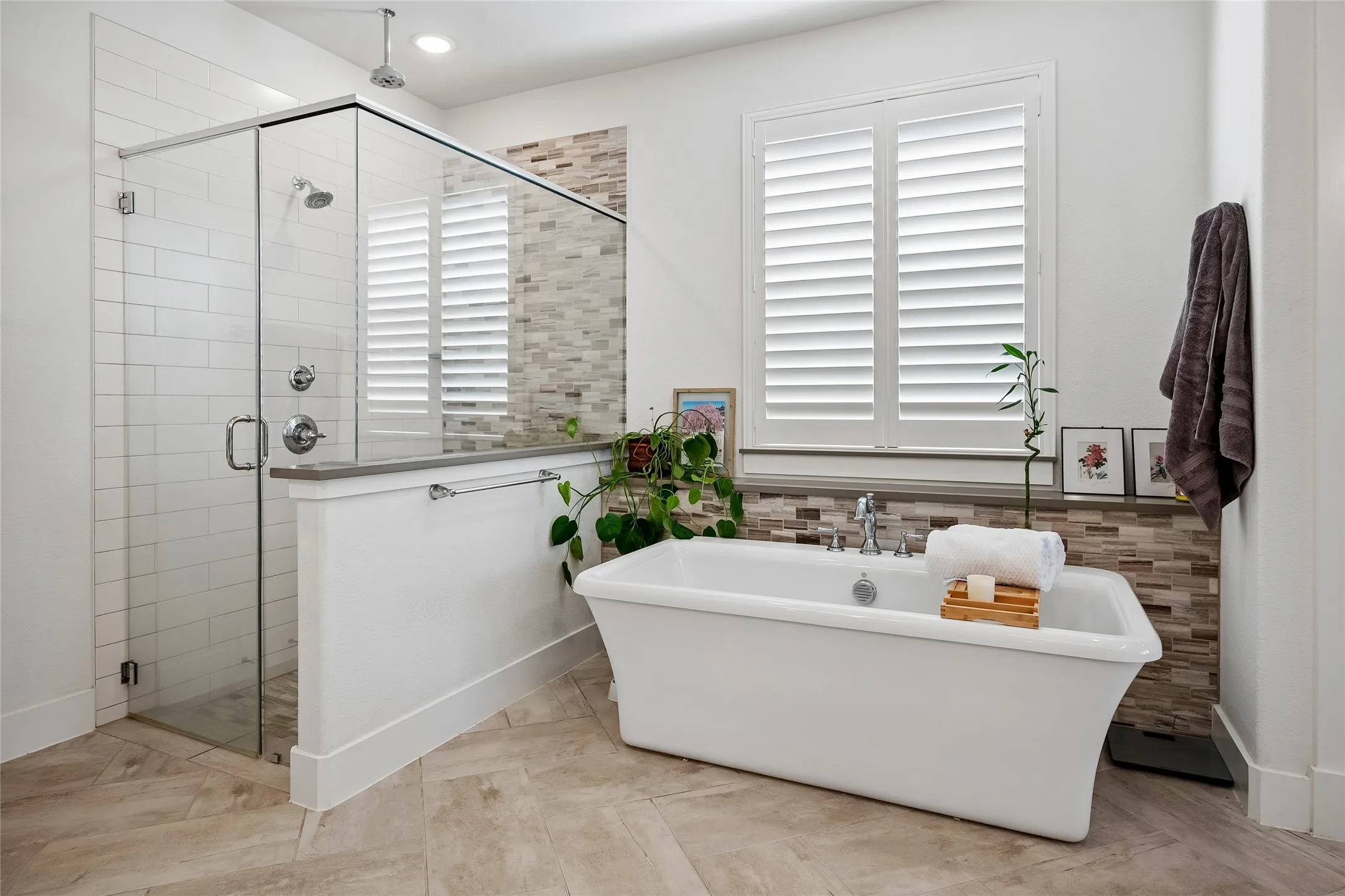 A better view of the large shower and shutters allowing allowing for natural light and privacy