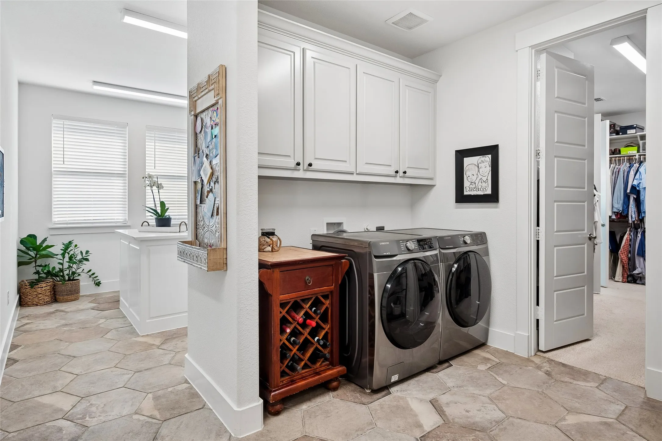 Closet door opens to the primary bedroom suite from the laundry room.