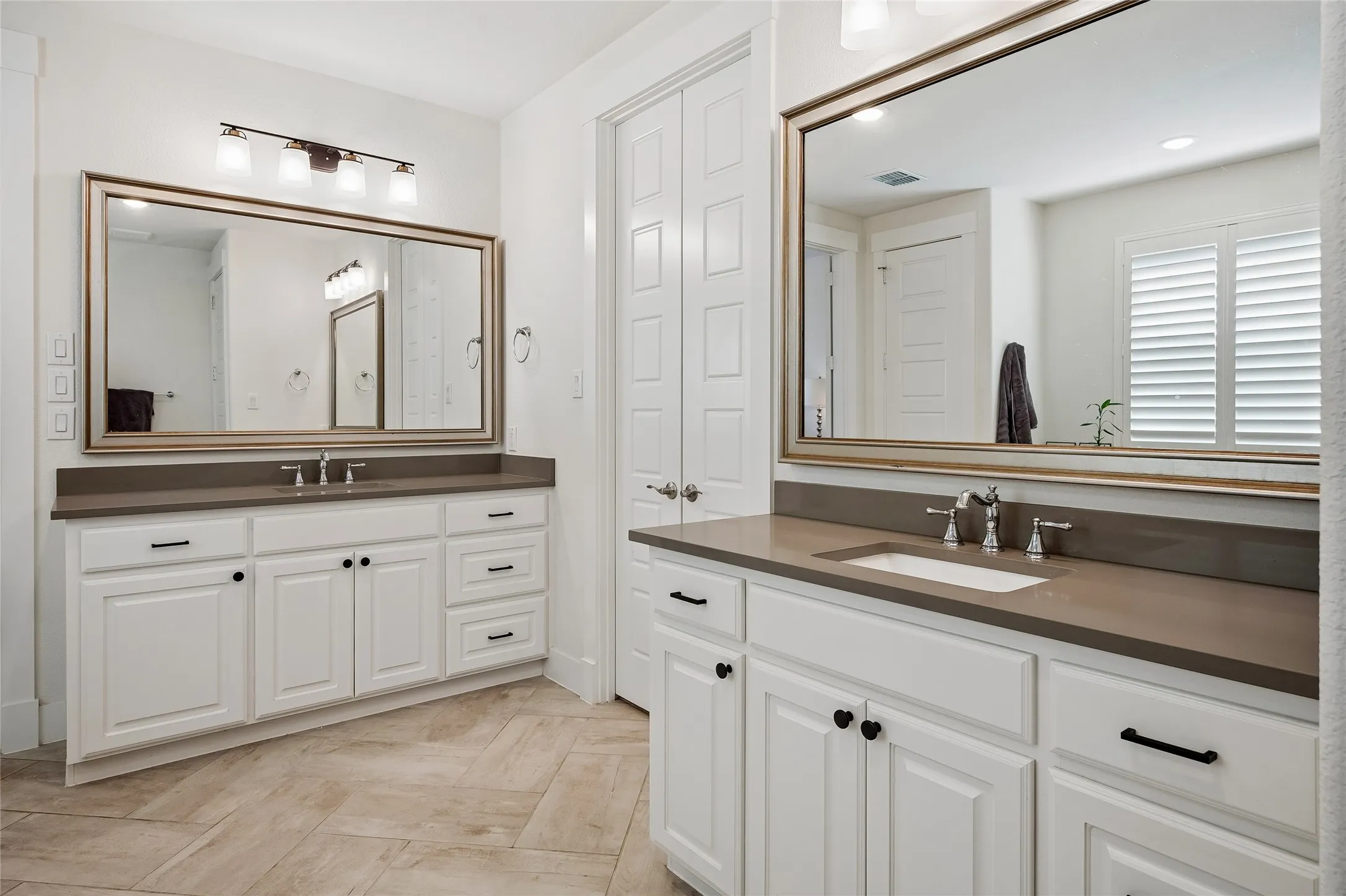 The door between the vanities opens to a spacious closet.