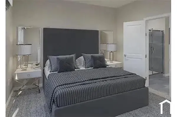 Plush carpeting, a padded headboard, and a white interior door