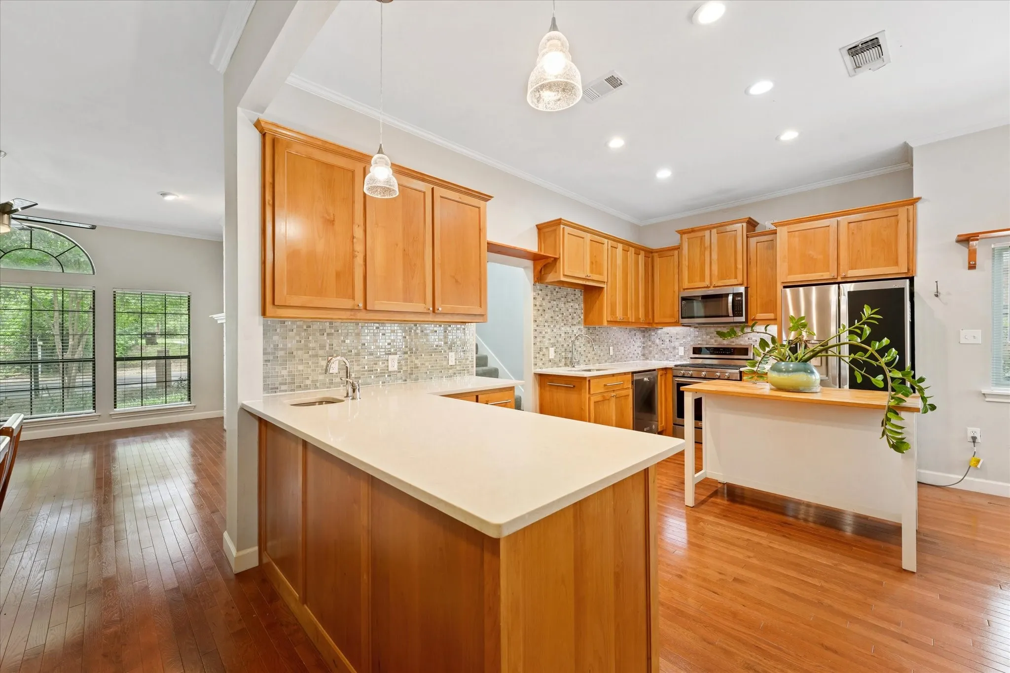 Updated kitchen with custom wood cabinetry, quartz-style countertops, stainless steel appliances, tile backsplash, and oversized breakfast​​‌​​​​‌​​‌‌​‌‌​​​‌‌​‌​‌​‌​​​‌​​ bar.