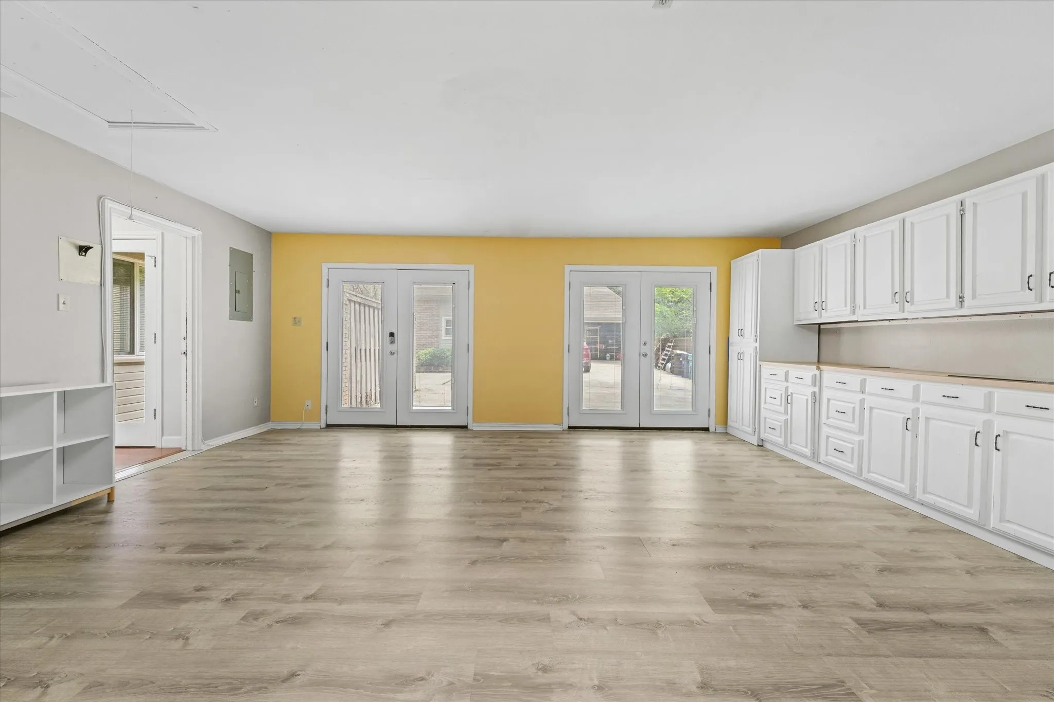 Oversized bonus room with built-in cabinetry, abundant storage, luxury vinyl plank flooring, and flexible layout for work, hobbies, media room, or guest overflow.
