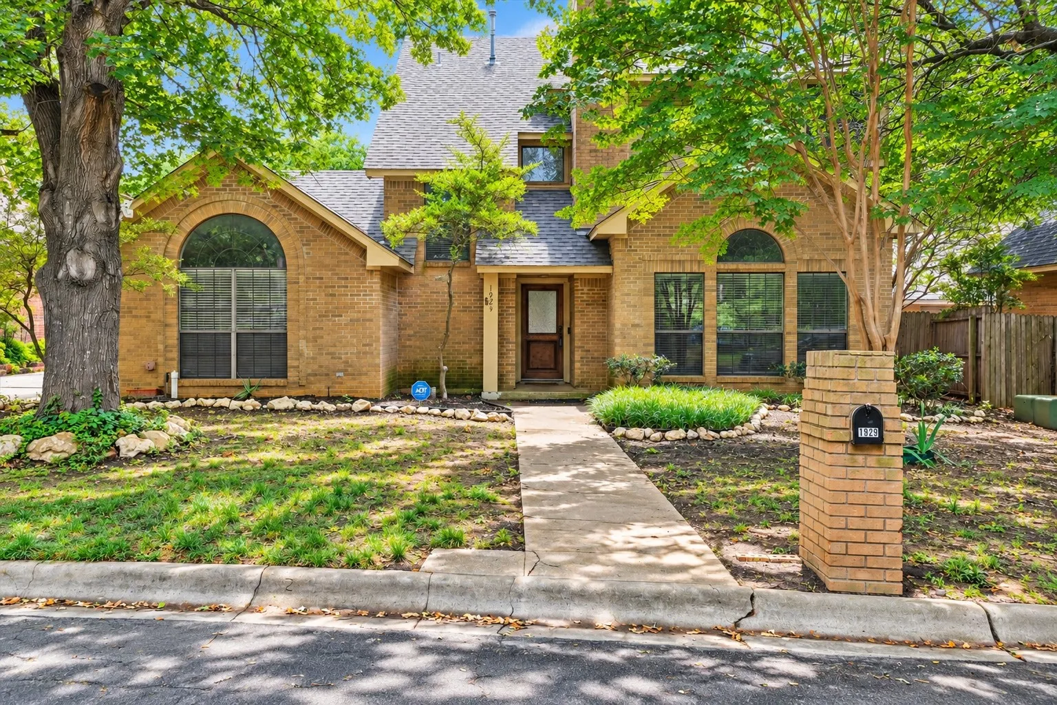 Mature trees and classic brick exterior create a private setting in one of Denton’s established neighborhoods near UNT and I-35E.