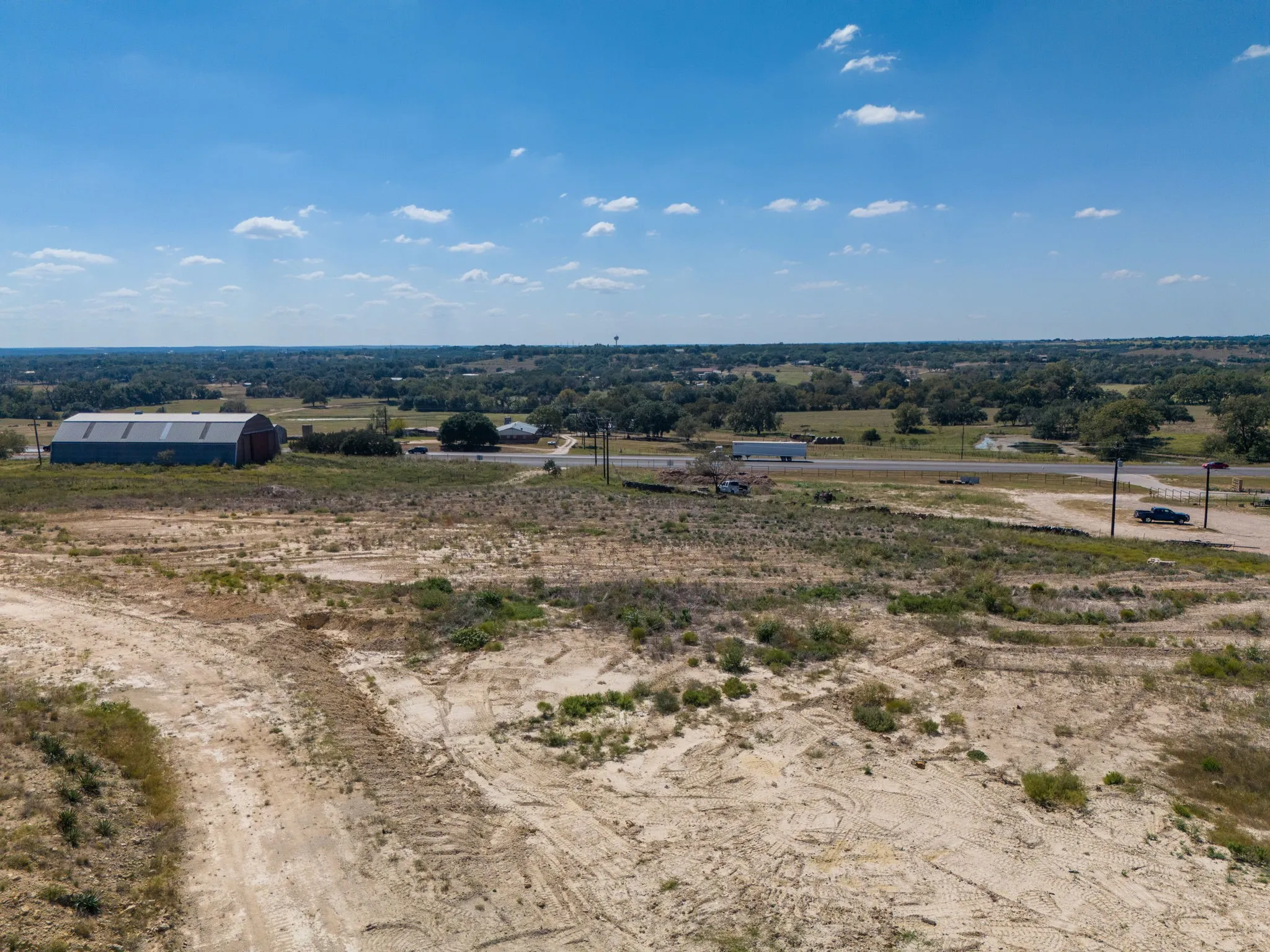 Expansive undeveloped terrain with visible roadway access