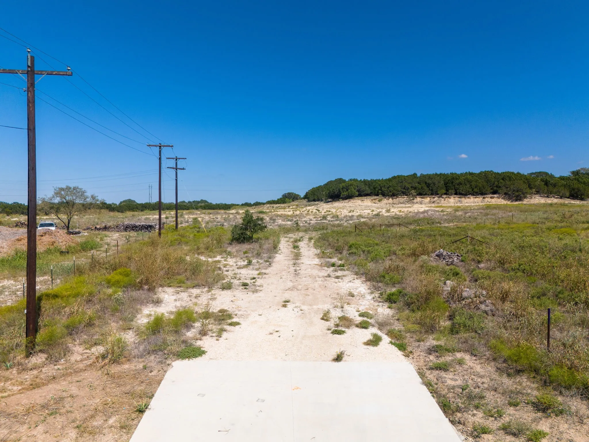 Expansive land parcel featuring open terrain and distant tree lines