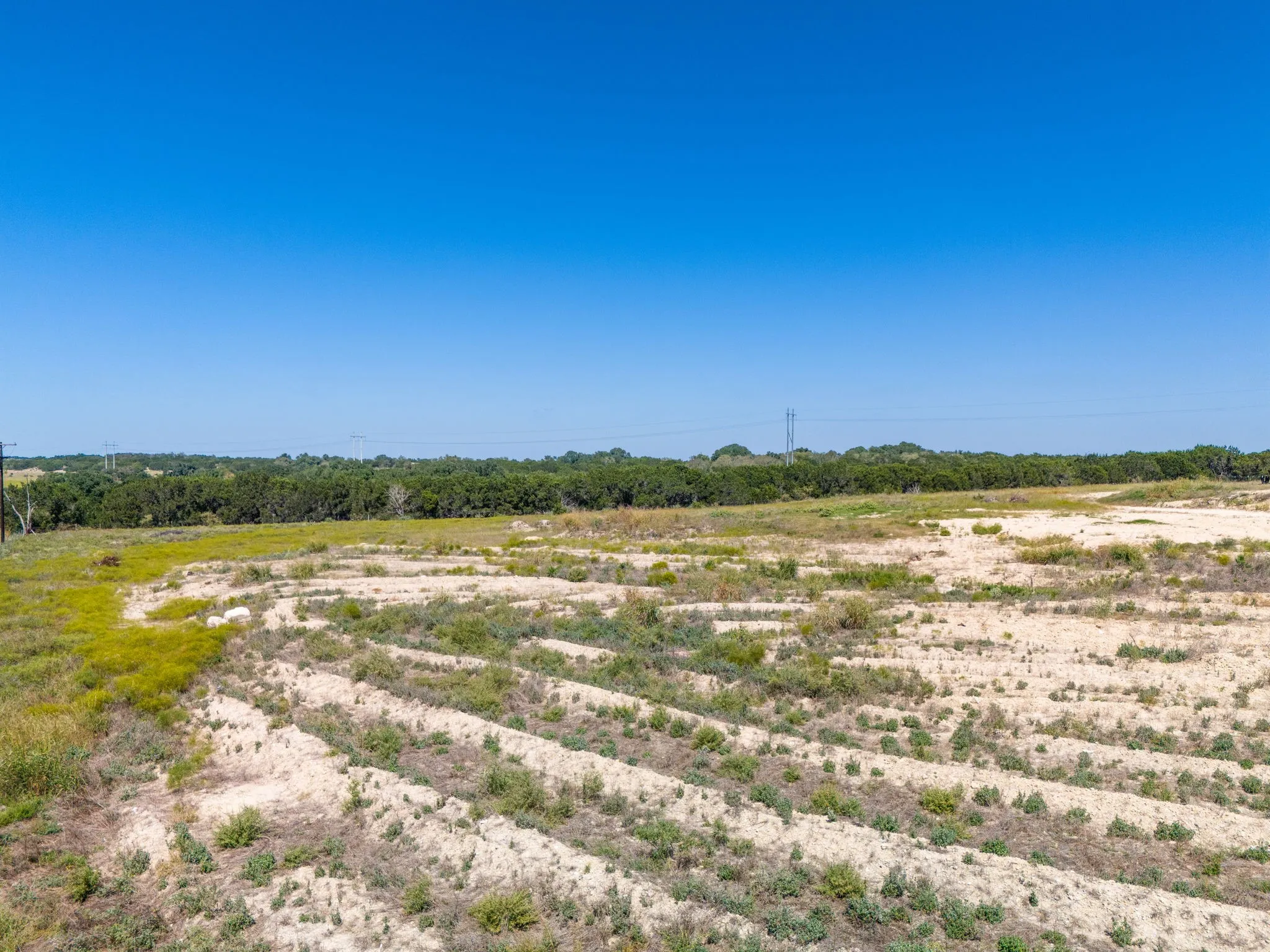 Expansive land parcel with varied topography and natural vegetation