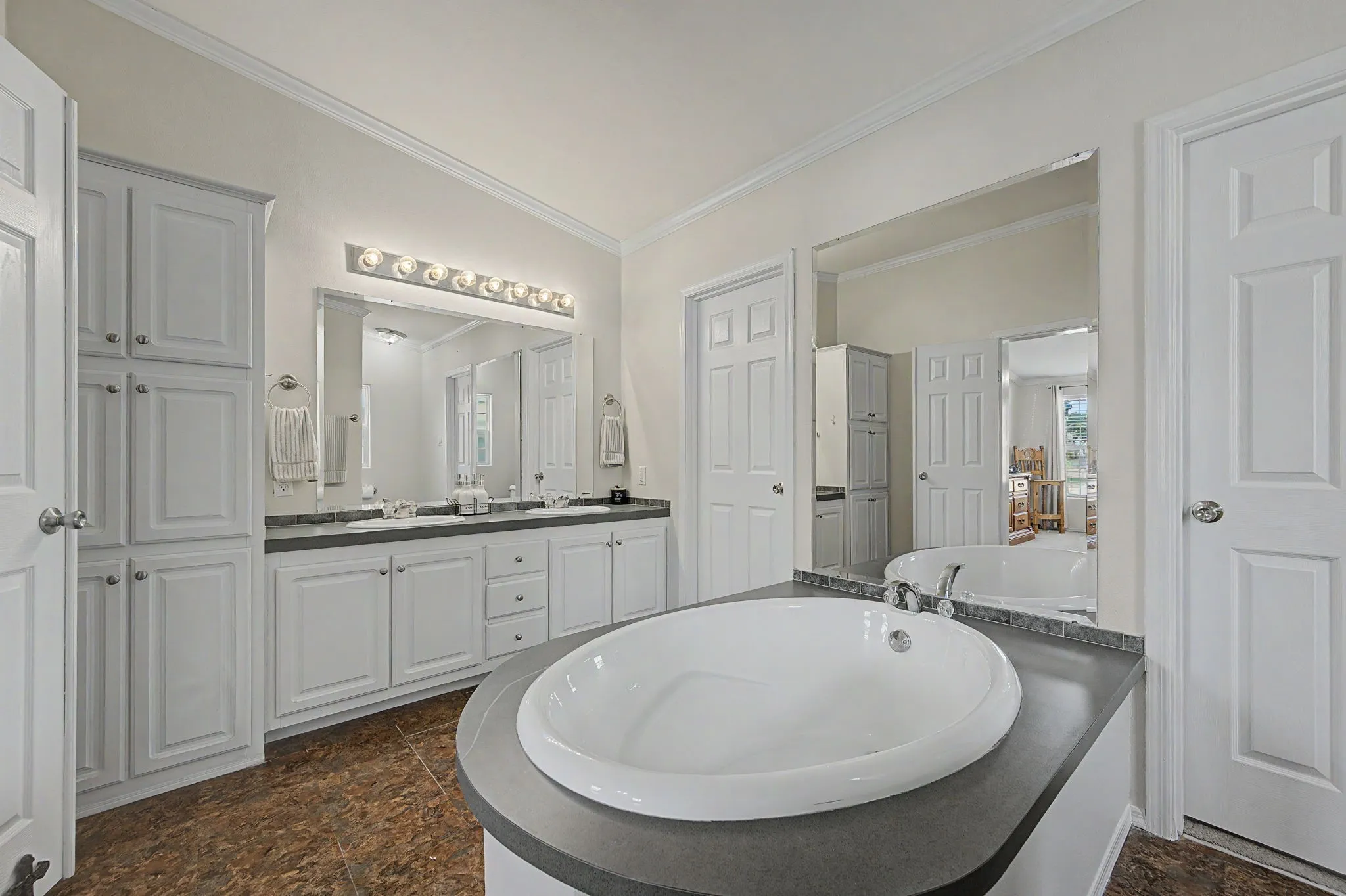 Huge soaker tub is the centerpiece for this room.