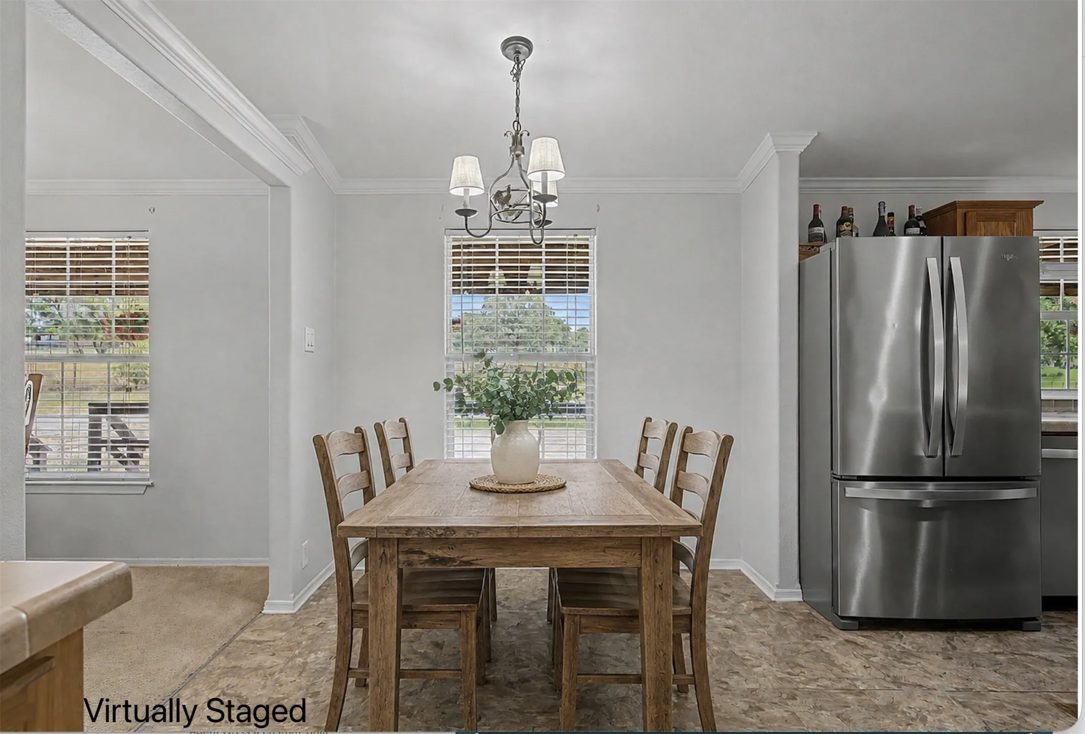 Separate breakfast nook area with chandelier. *Virtually staged table.
