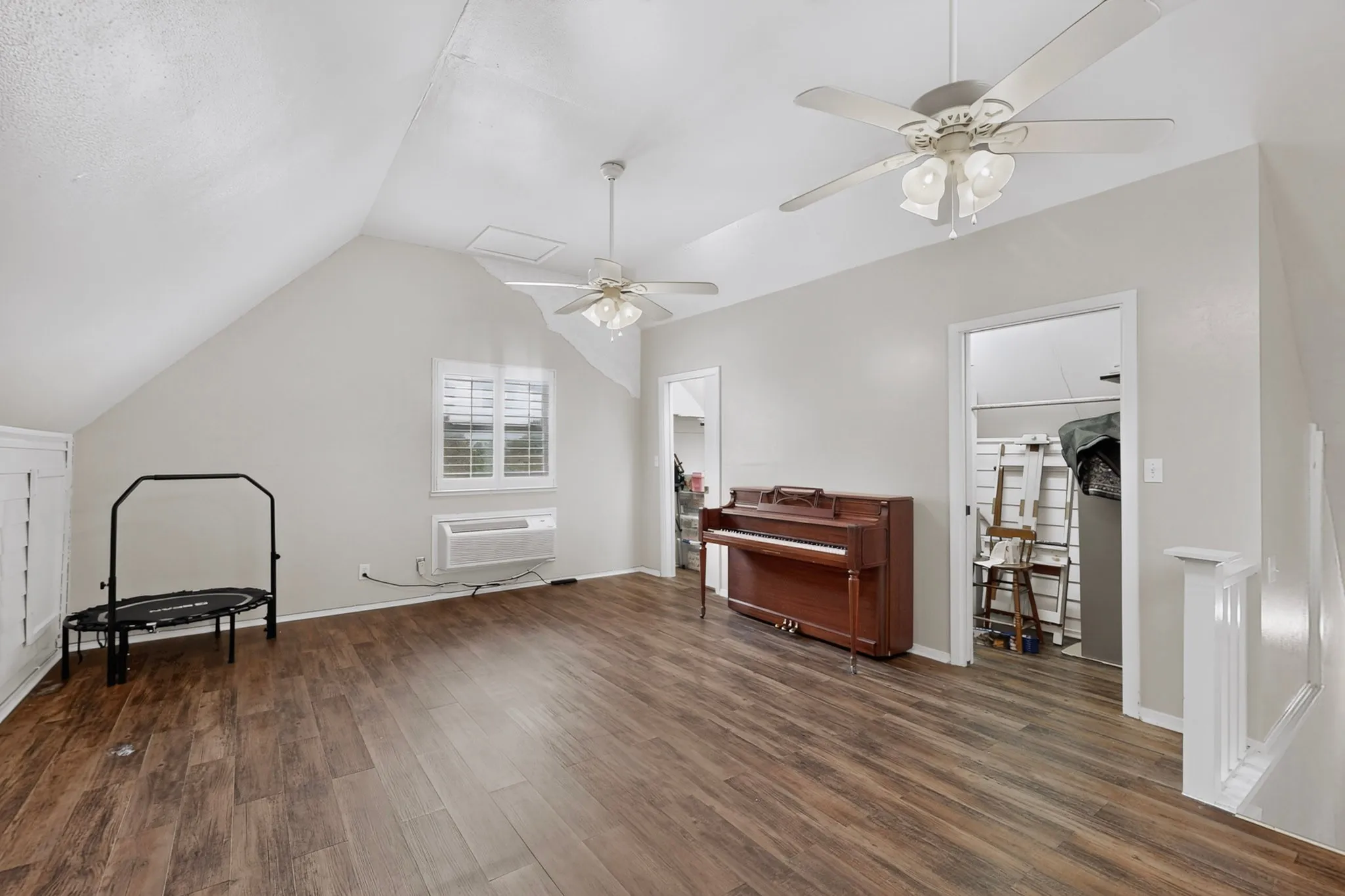 Wood-finish flooring throughout, complemented by sloped ceilings