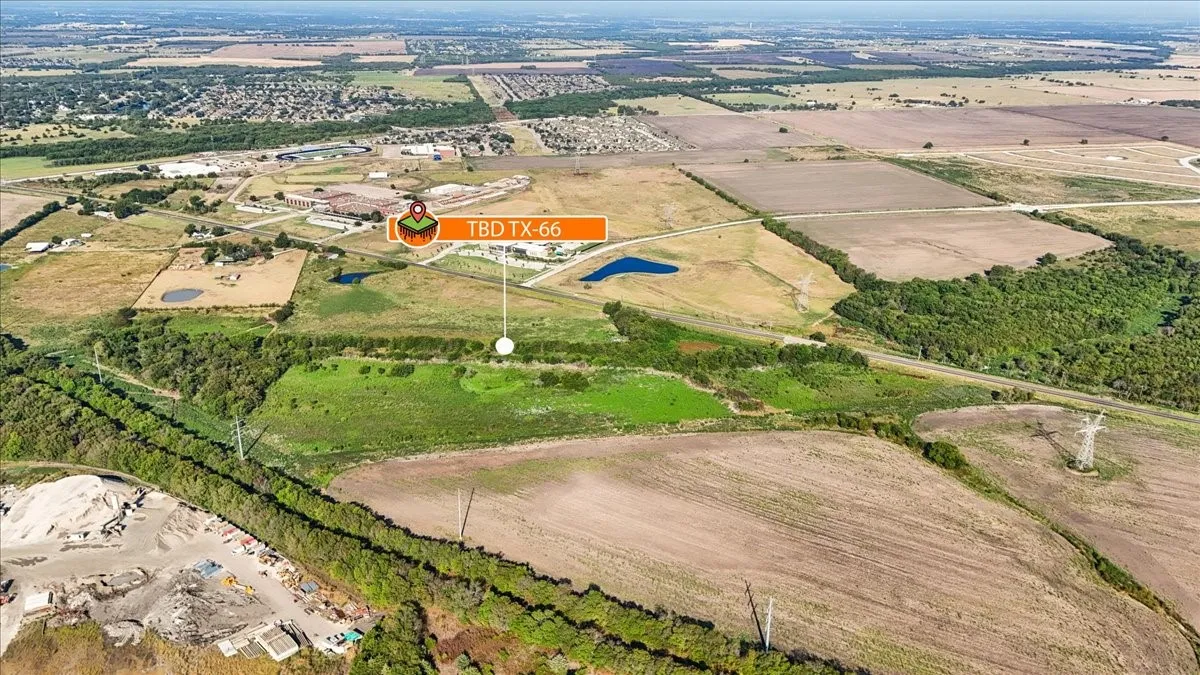 Expansive land parcel with open fields and wooded areas