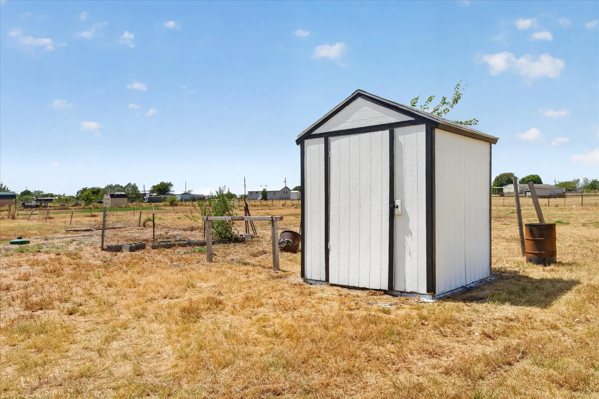 Freestanding storage shed with a gabled roof and a single entry door