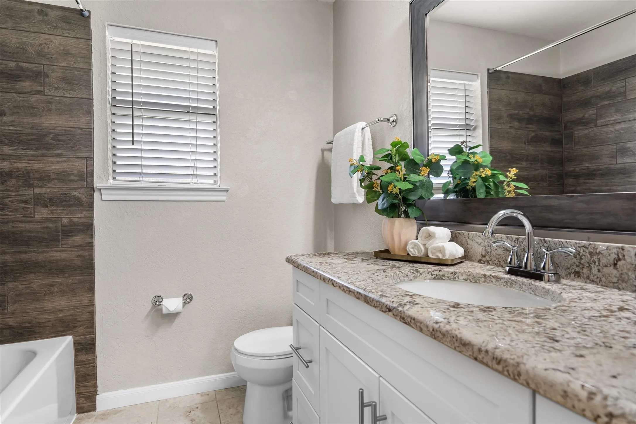 Hall Bathroom with updated cabinets and granite countertop