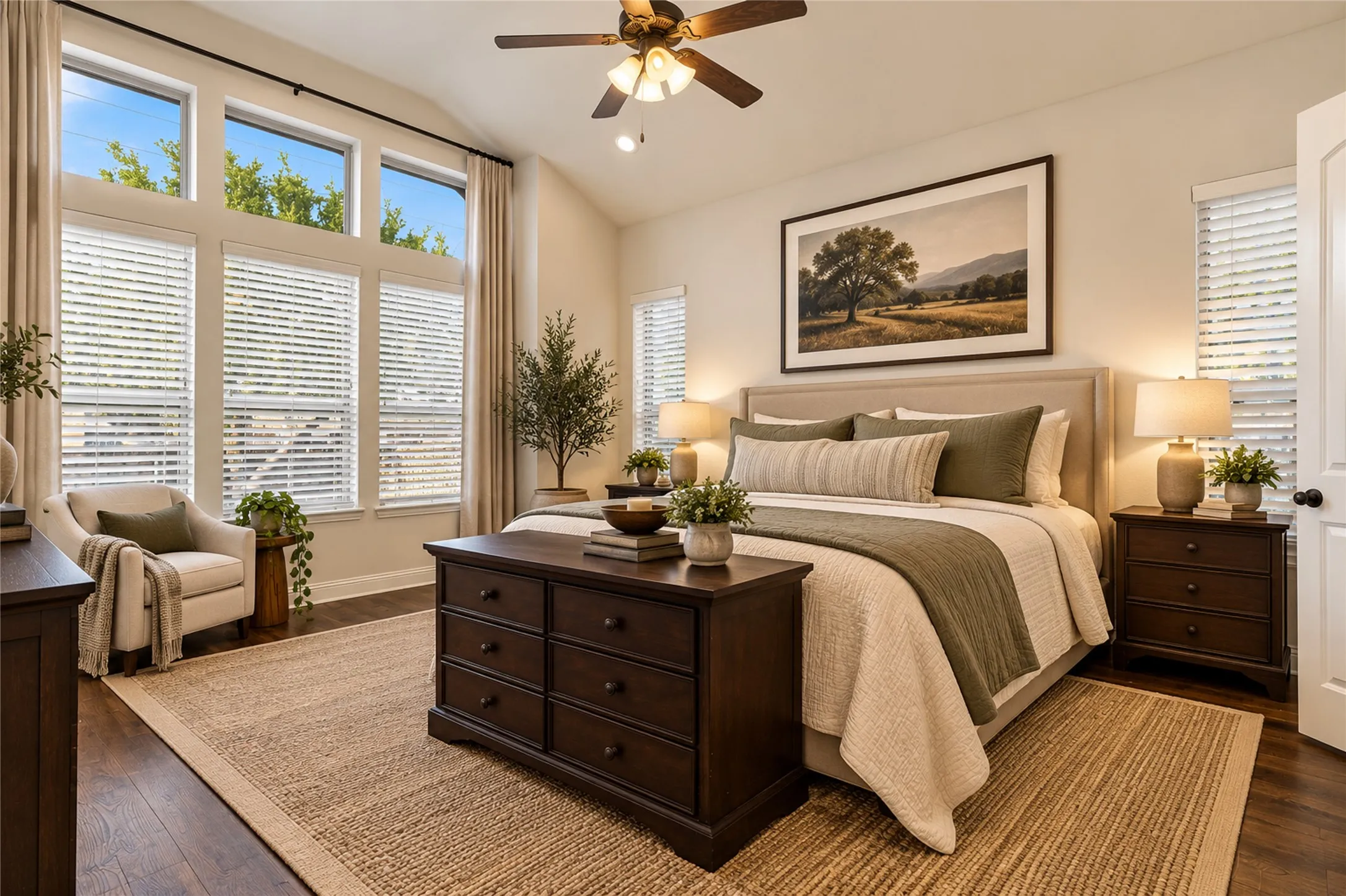 Vaulted ceiling featuring a ceiling fan, abundant natural light from multiple windows, dark wood-finish flooring, and light-toned walls