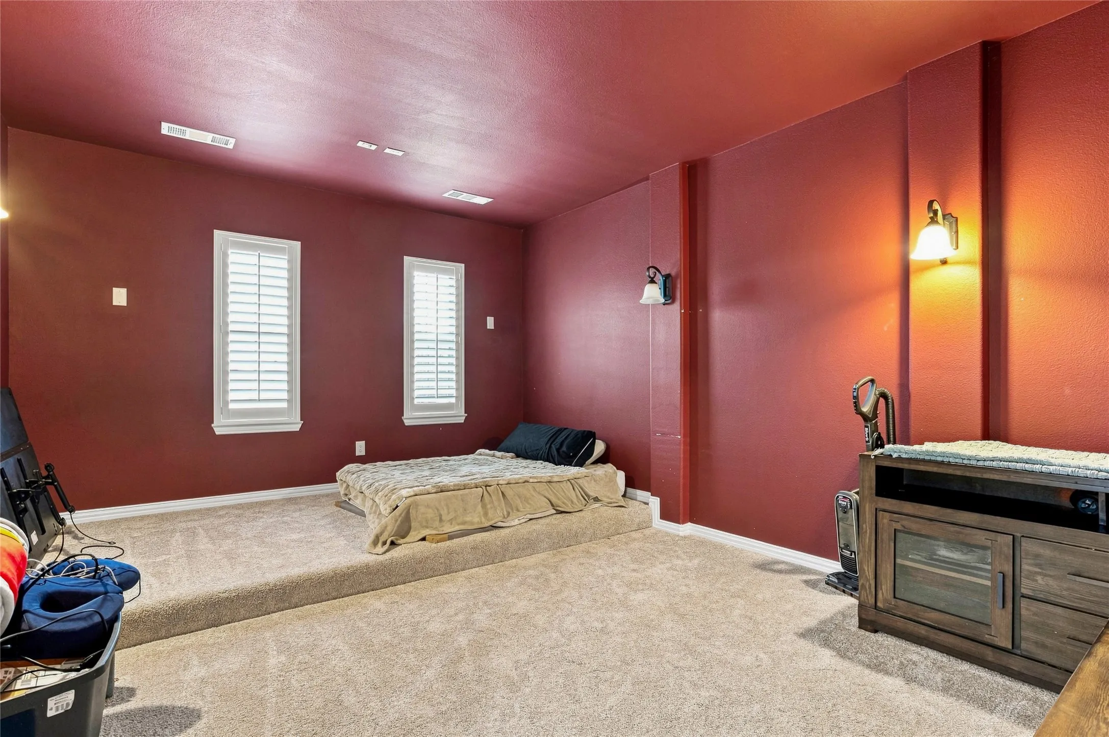 Carpeted flooring, recessed lighting, and wall sconces