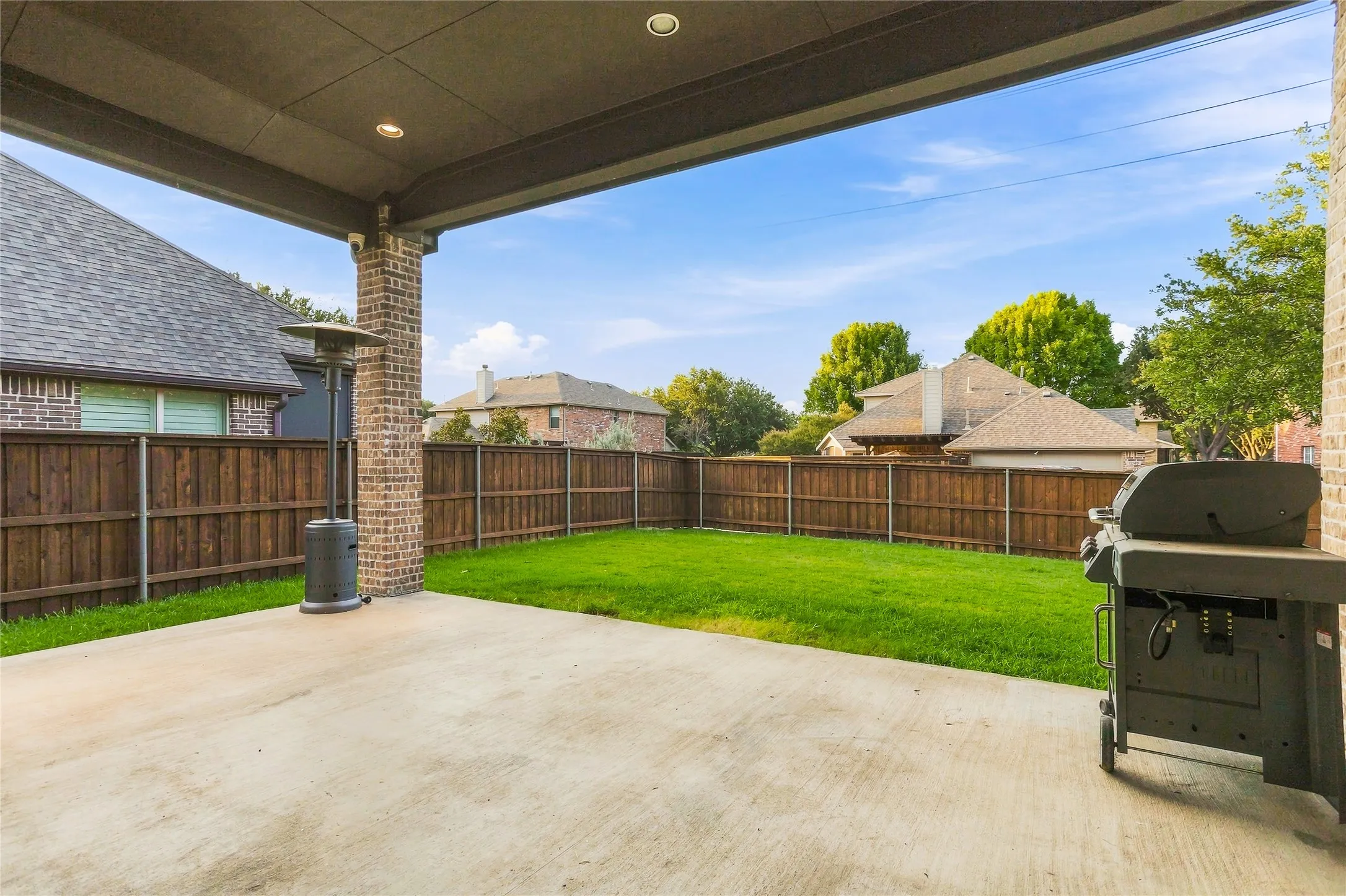 Covered patio with recessed lighting, brick column, and concrete flooring