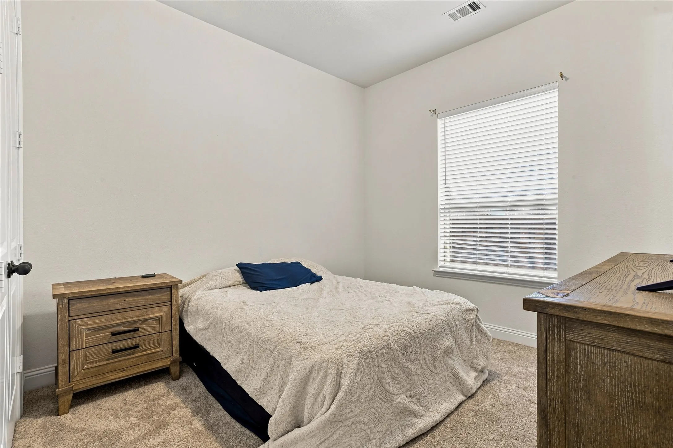 Neutral-toned walls complement the carpeted flooring
