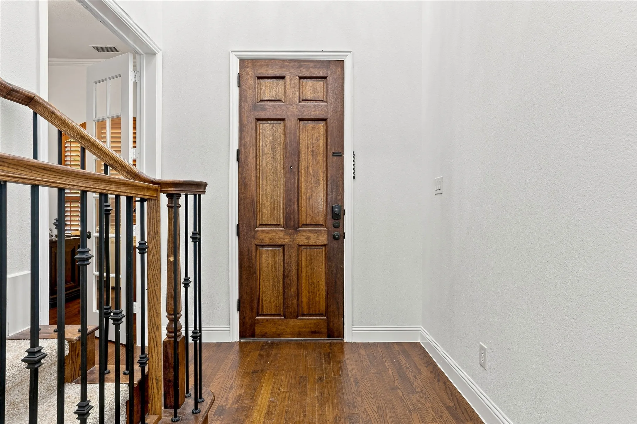 Hardwood flooring and a solid wood paneled door