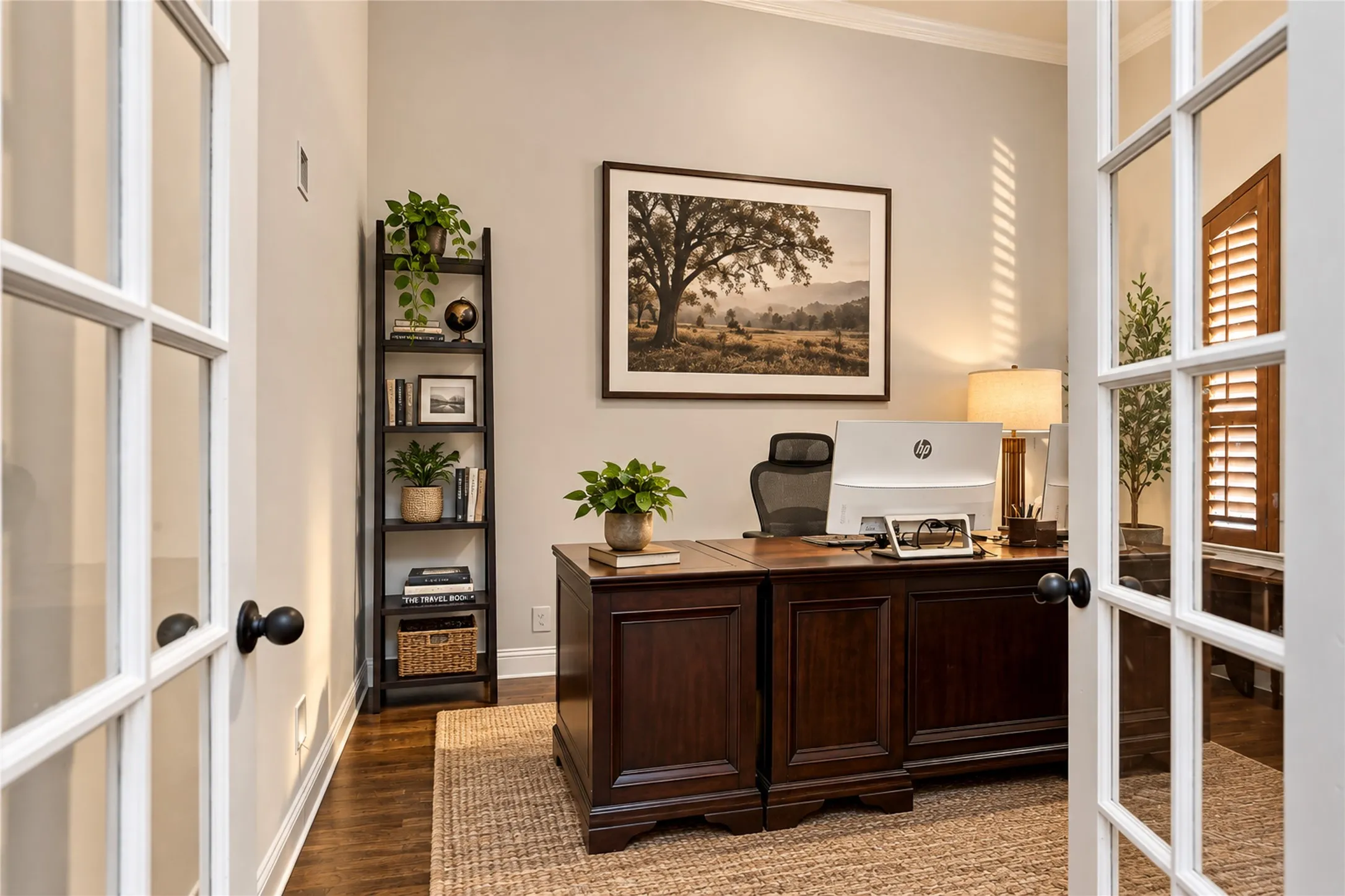 French doors with clear glass panes open into a room featuring wood-finish flooring, crown molding, and plantation shutters
