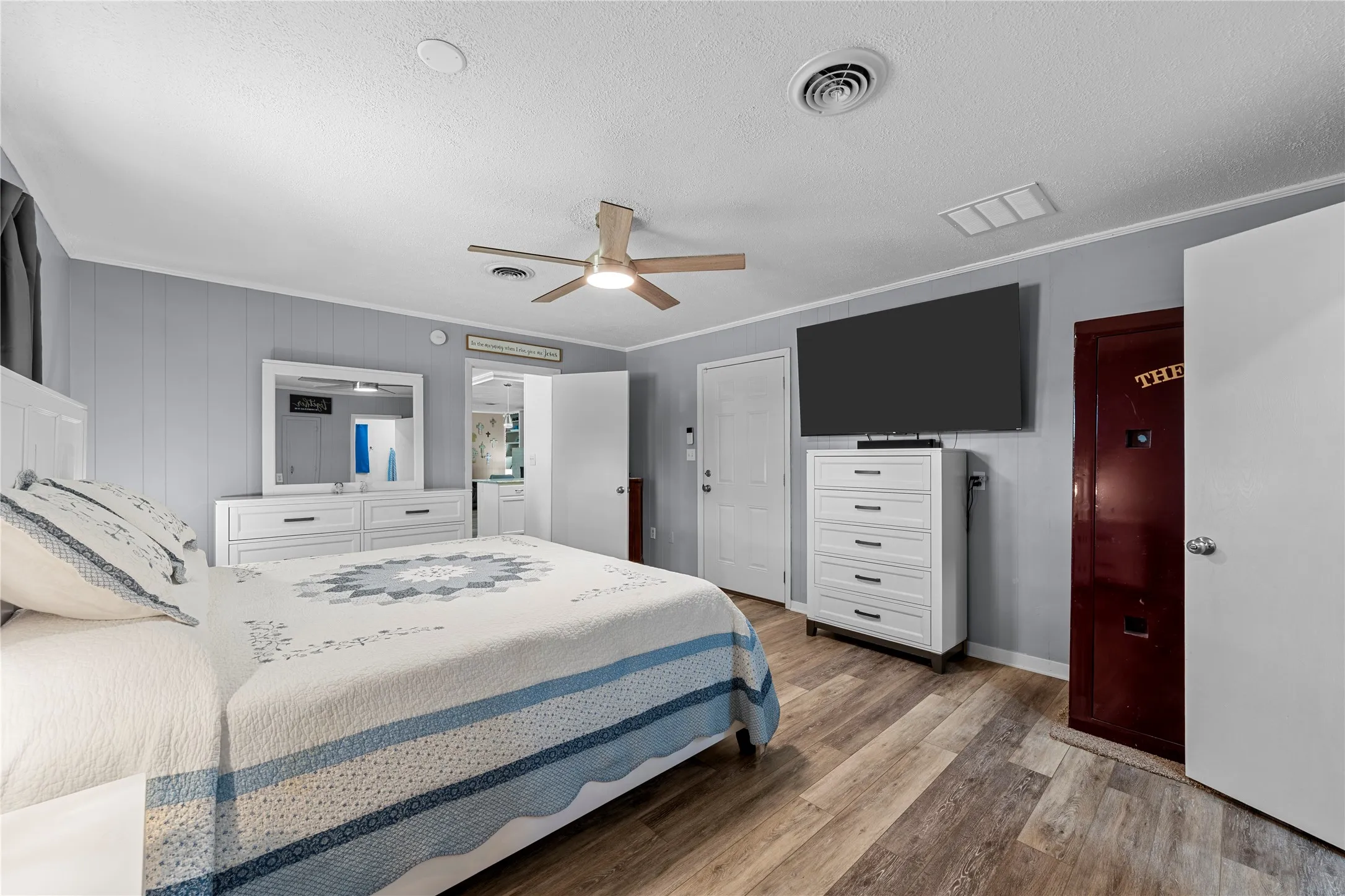 Wood-finish flooring with a ceiling fan light fixture
