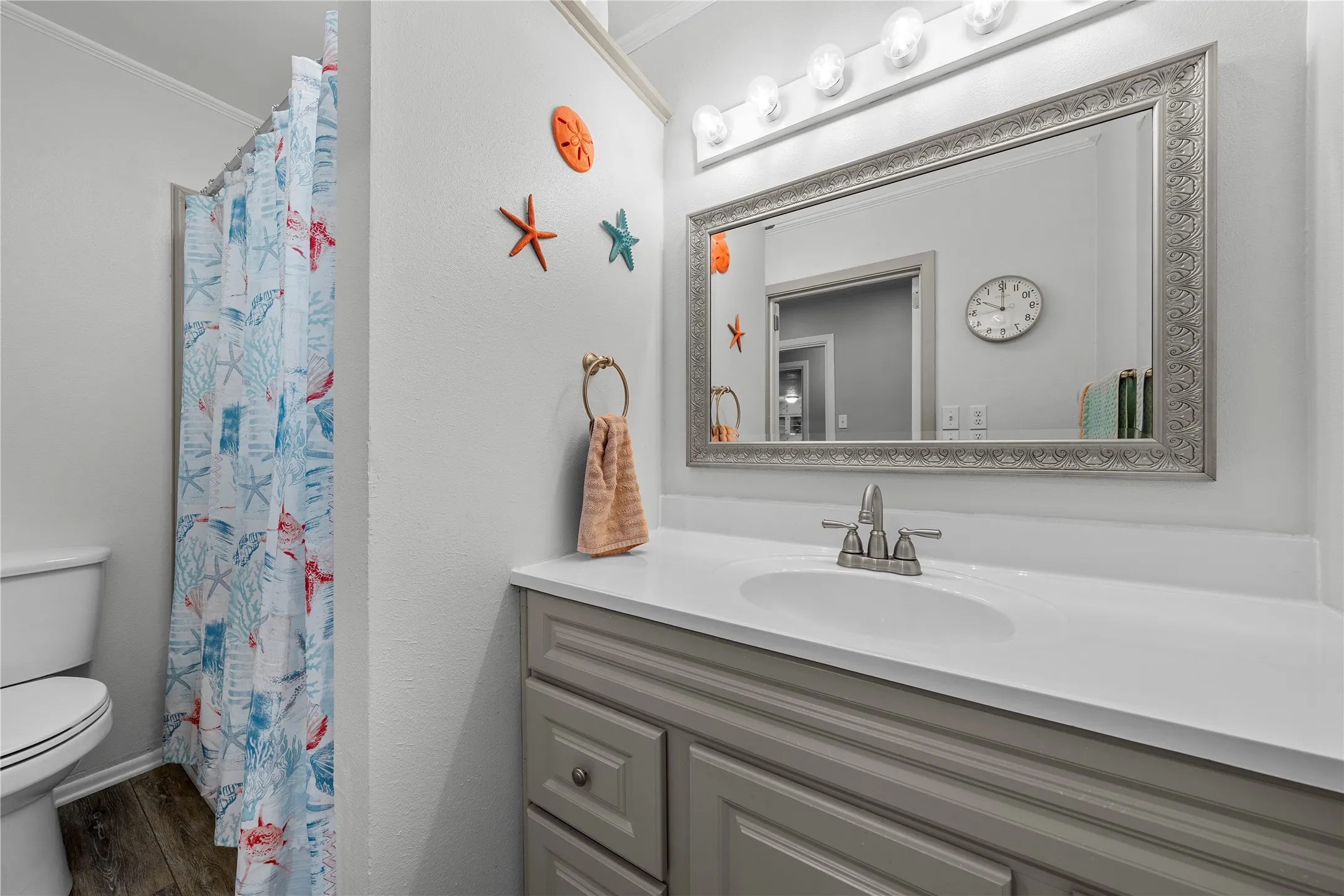 Vanity with a single basin, undermount sink, and a framed mirror