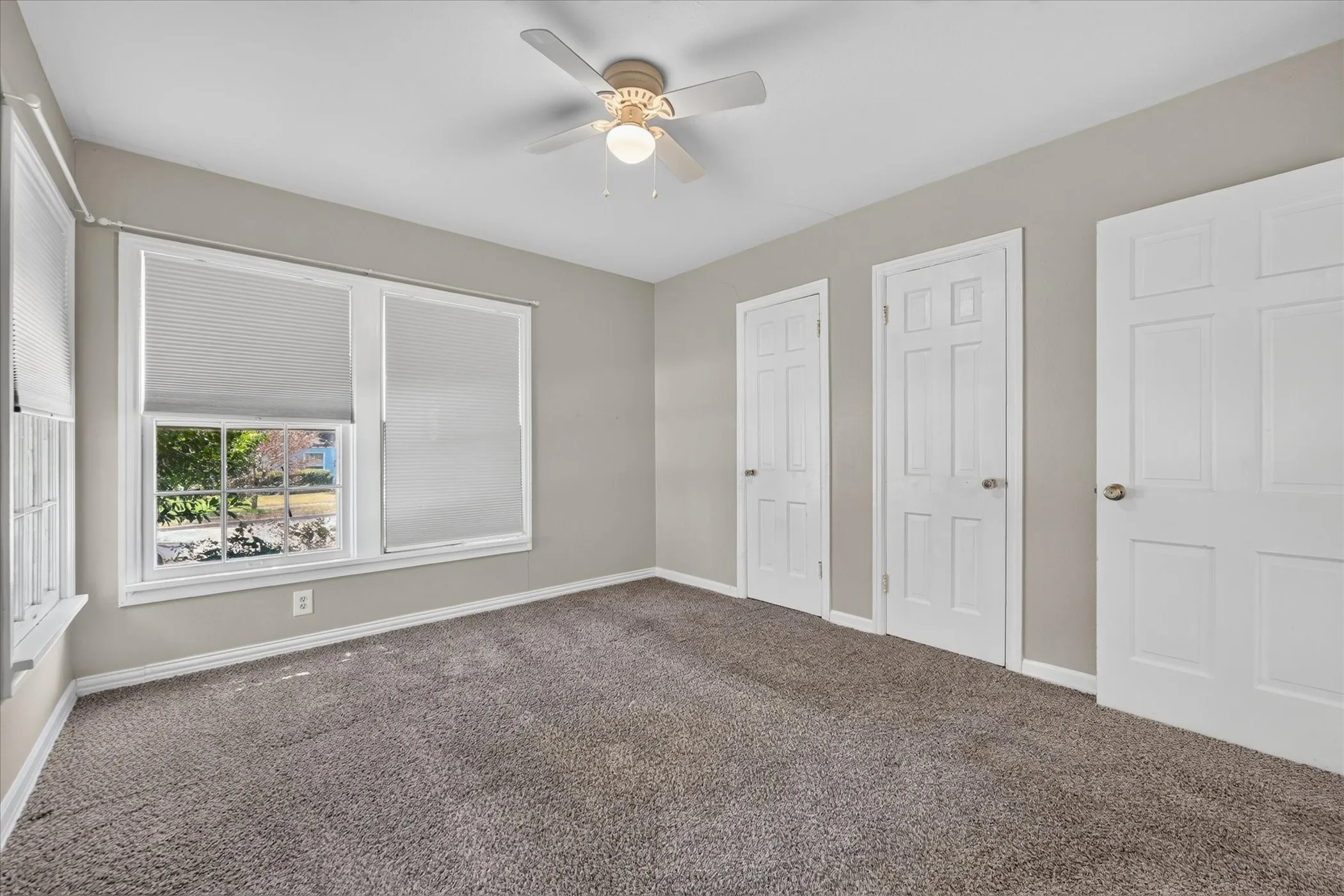 Neutral wall paint complemented by white trim and doors