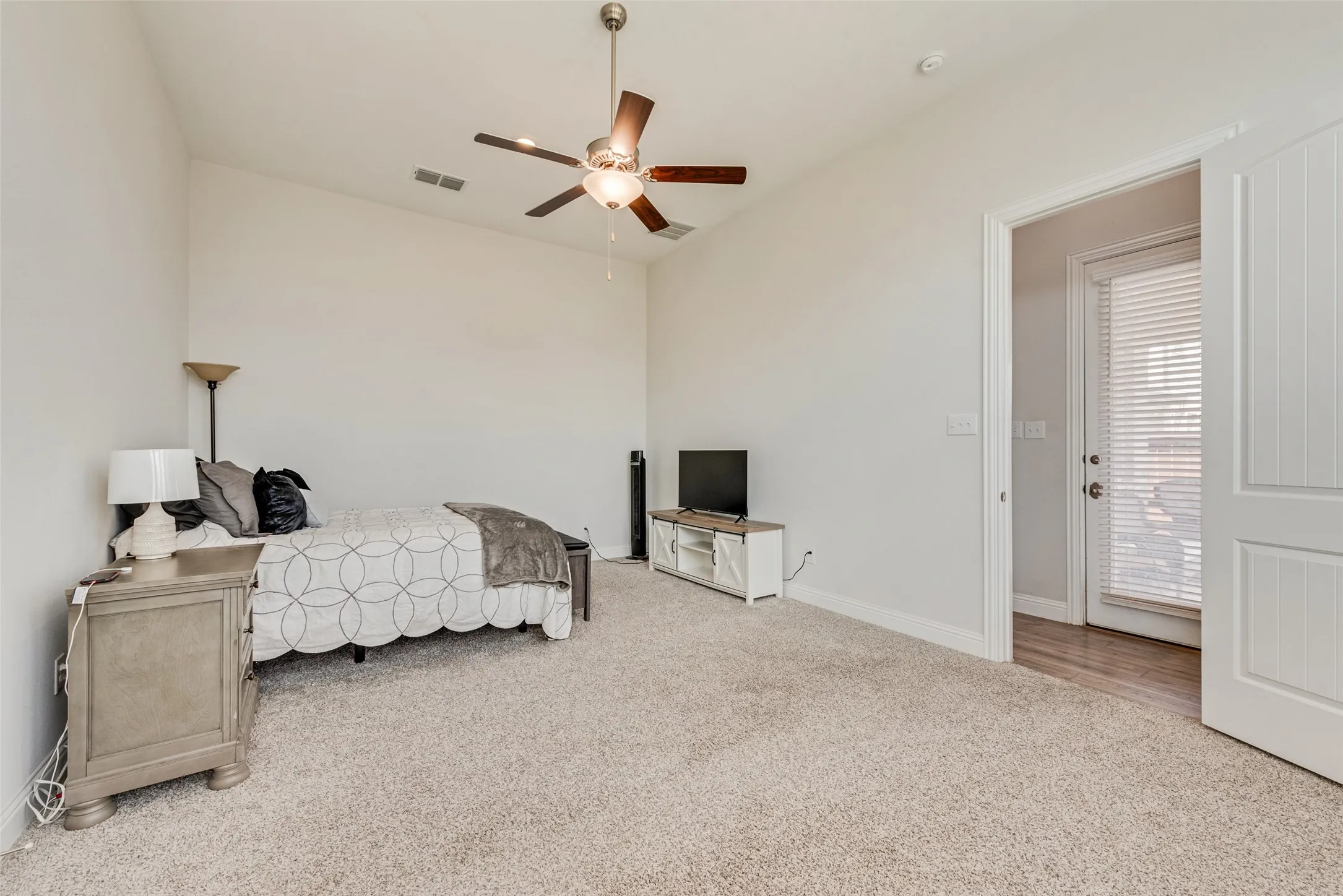Spacious primary bedroom with 11 ft ceilings at 1721 Pattenson Trl, Haslet, TX 76052 in Wellington subdivision