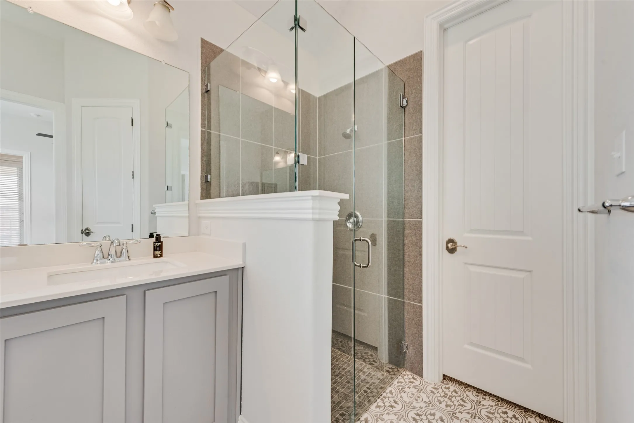 Primary bathroom with gorgeous tile floors, shaker cabinets and 11 ft ceilings at 1721 Pattenson Trl, Haslet, TX 76052 in Wellington subdivision