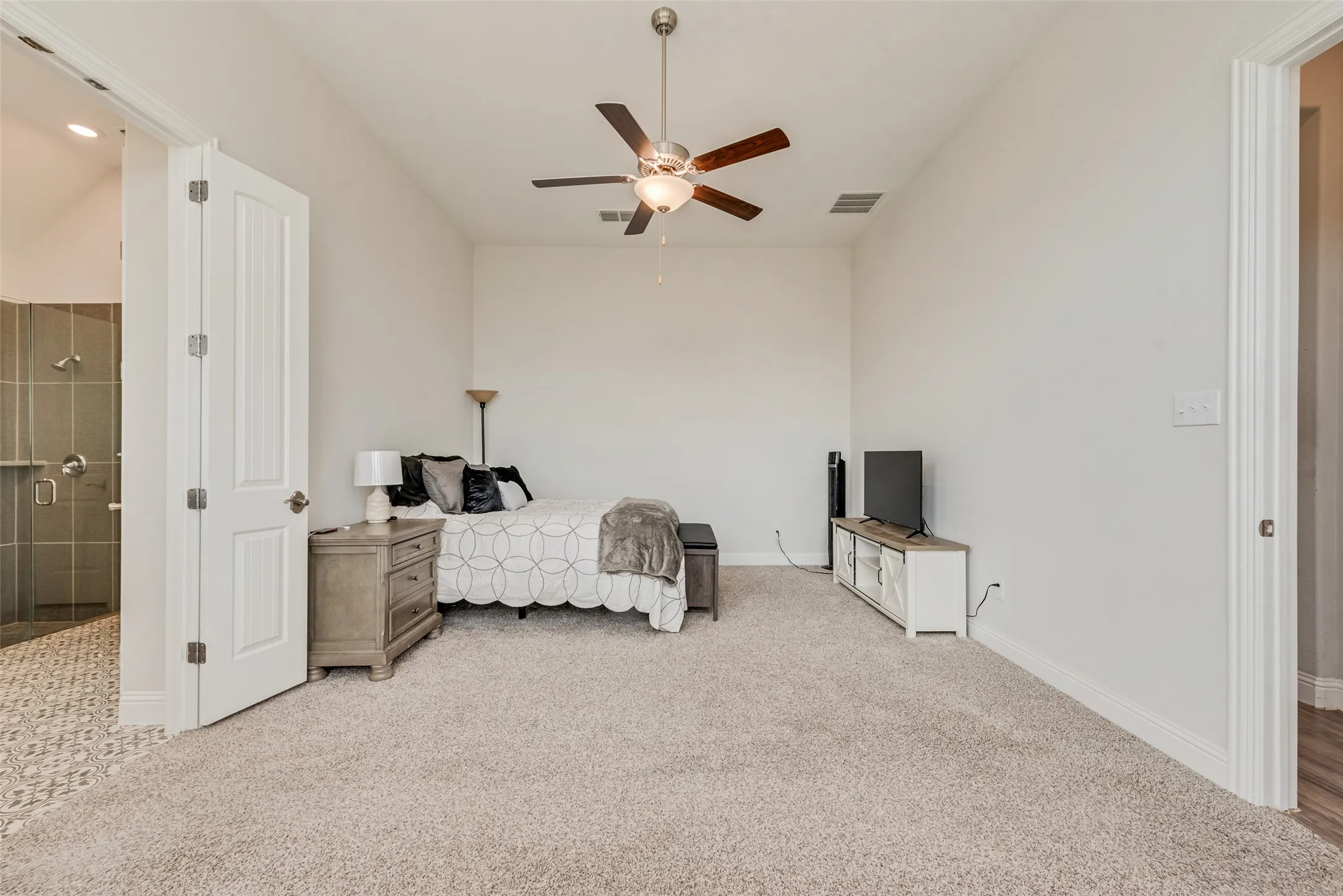 Spacious primary bedroom with 11 ft ceilings at 1721 Pattenson Trl, Haslet, TX 76052 in Wellington subdivision