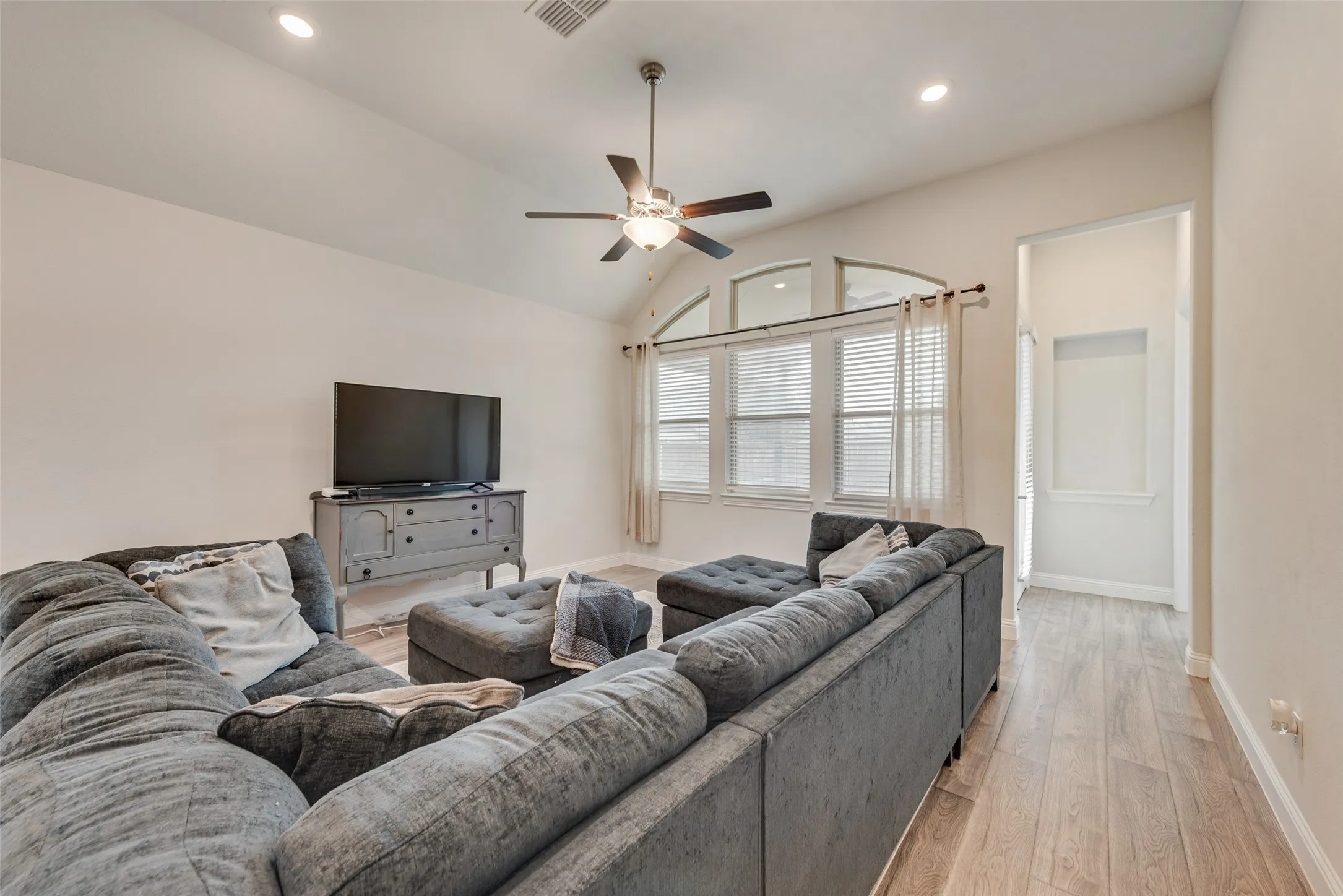 Living room with engineered hardwood floors and 11 ft ceilings at 1721 Pattenson Trl, Haslet, TX 76052 in Wellington subdivision