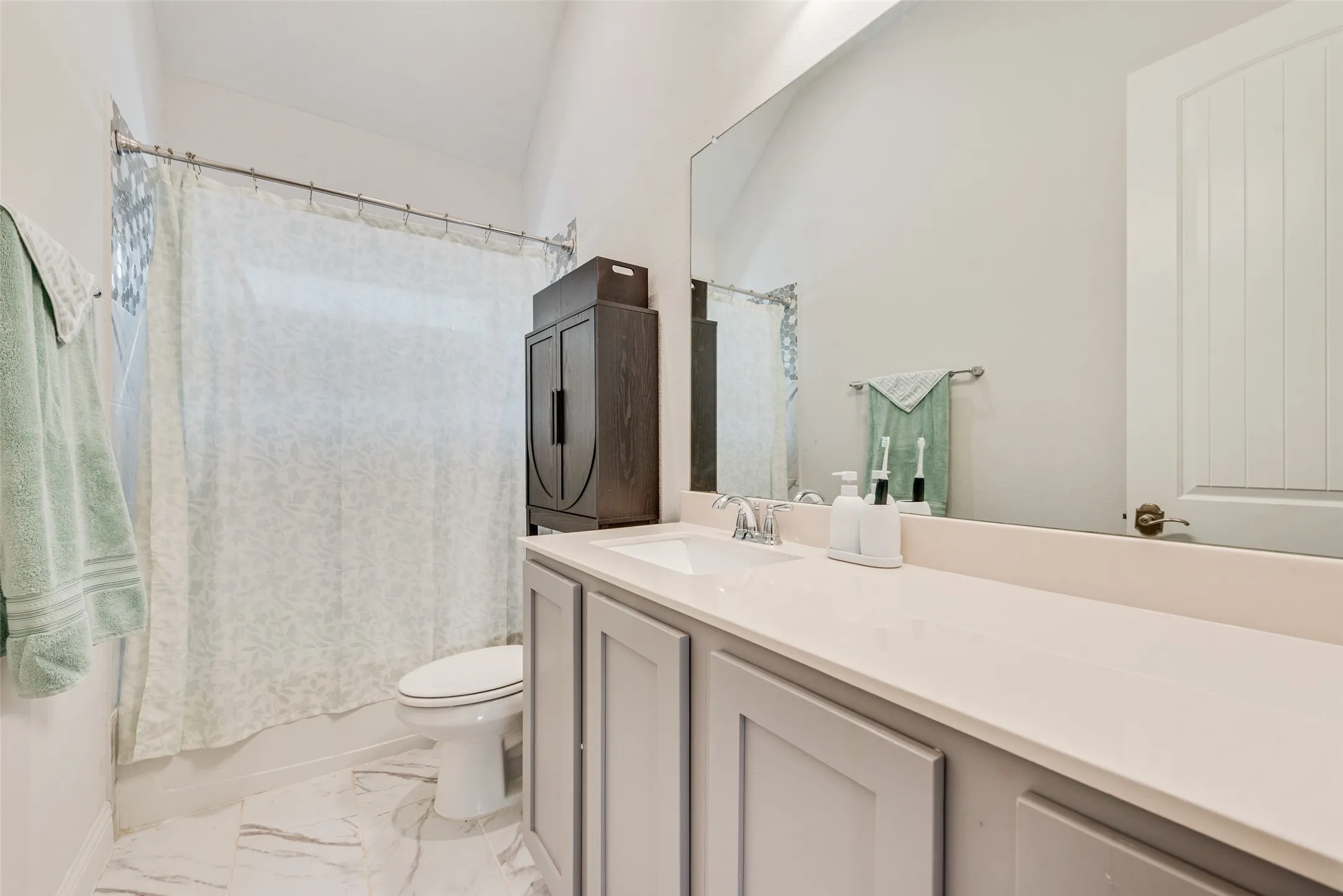 Hall bathroom with tile floors and shaker cabinets at 1721 Pattenson Trl, Haslet, TX 76052 in Wellington subdivision