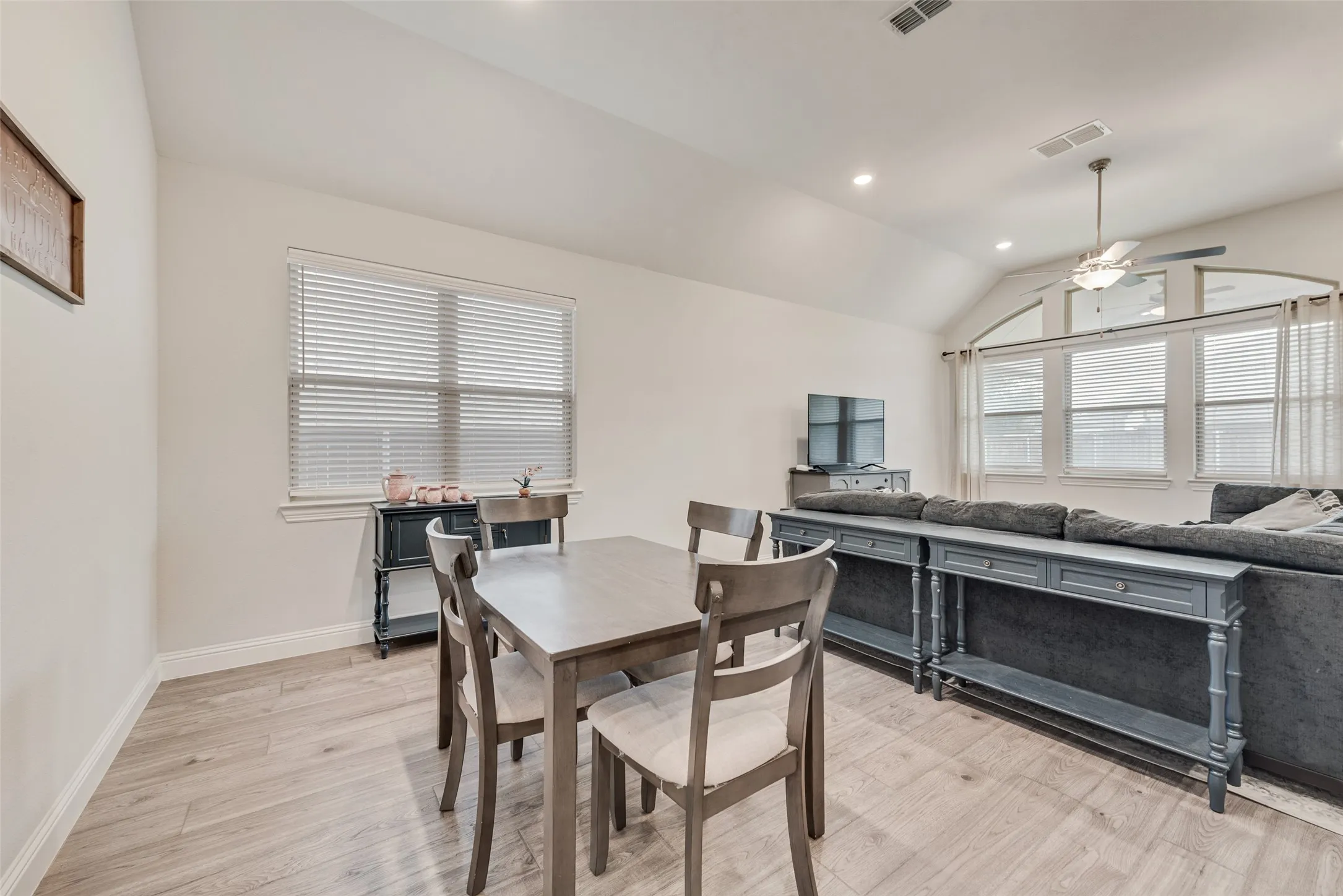 View into the dining room and living room with engineered hardwood floors and 11 ft ceilings at 1721 Pattenson Trl, Haslet, TX 76052 in Wellington subdivision