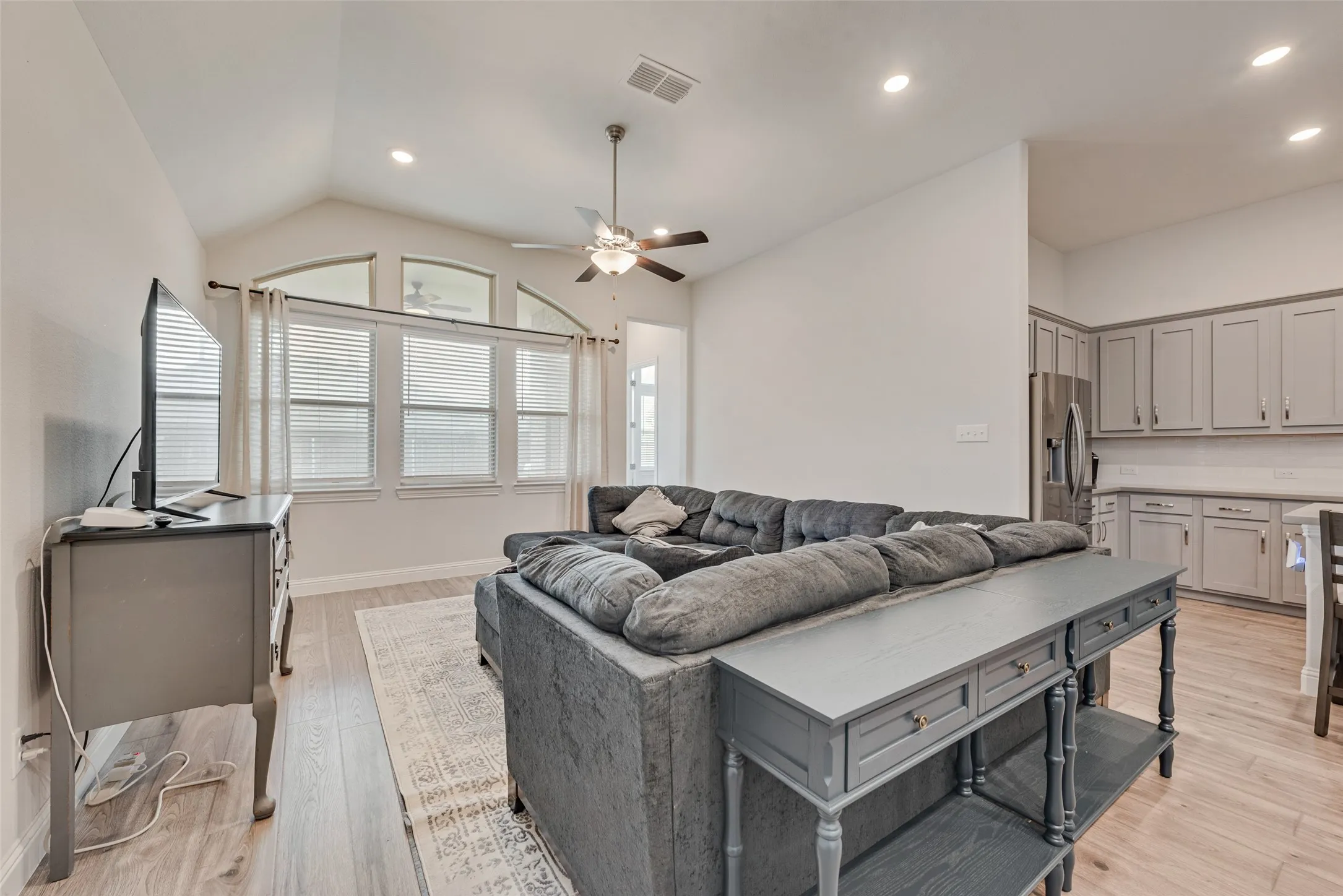 Living room with engineered hardwood floors and 11 ft ceilings at 1721 Pattenson Trl, Haslet, TX 76052 in Wellington subdivision