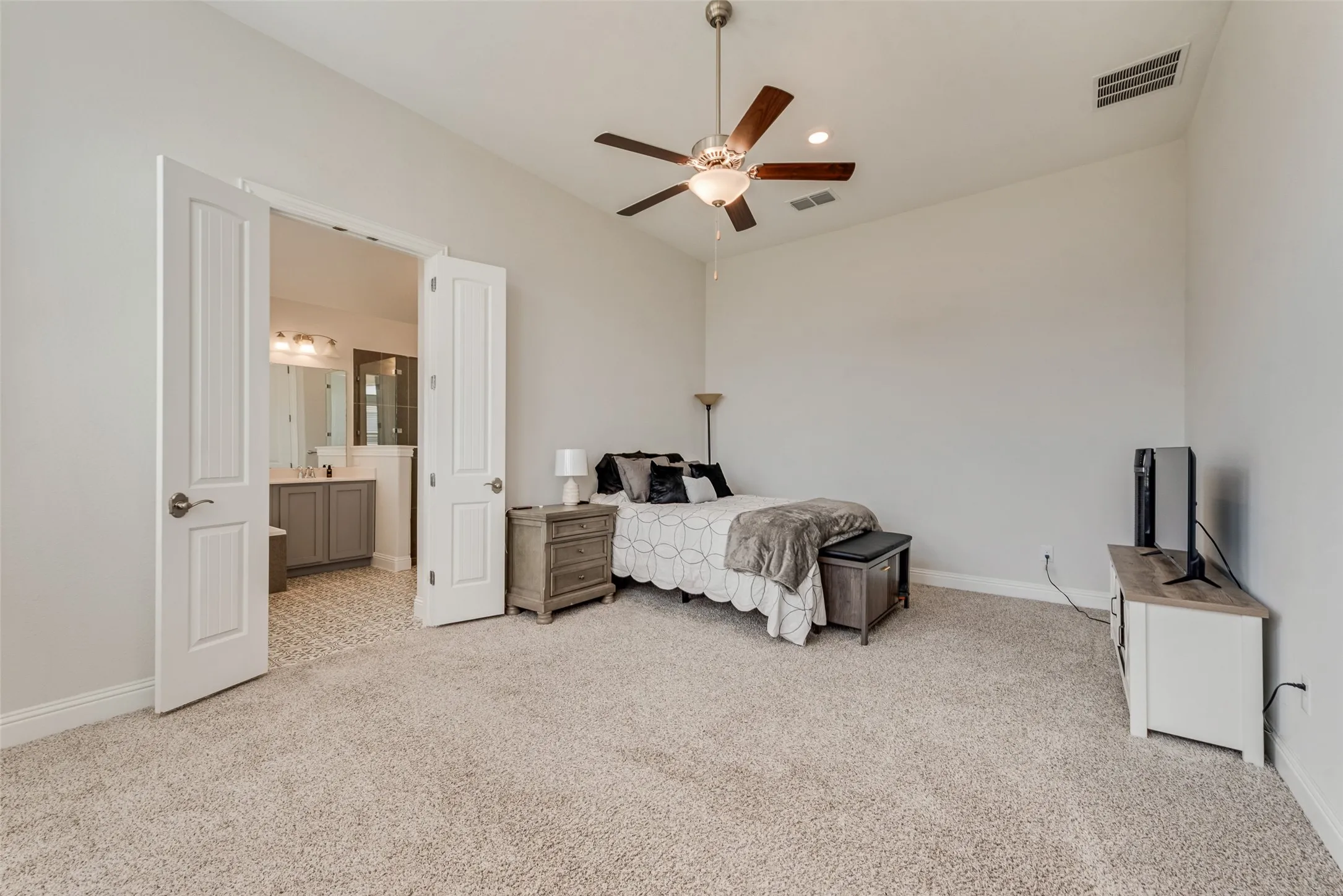 Spacious primary bedroom with 11 ft ceilings at 1721 Pattenson Trl, Haslet, TX 76052 in Wellington subdivision