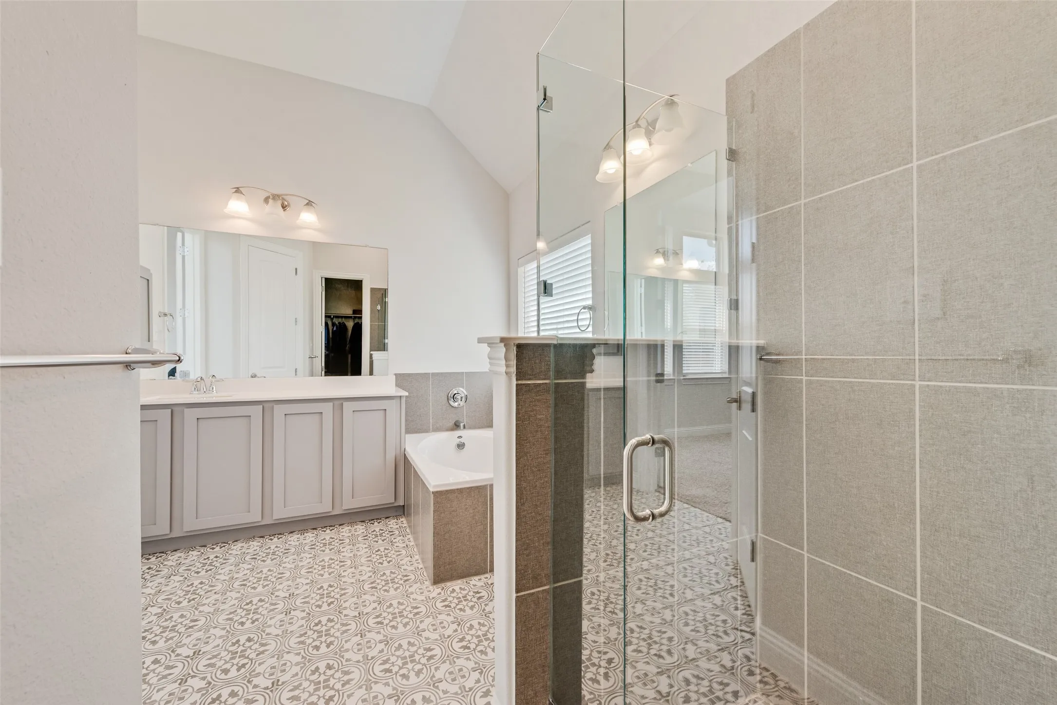 Primary bathroom with gorgeous tile floors, shaker cabinets and 11 ft ceilings at 1721 Pattenson Trl, Haslet, TX 76052 in Wellington subdivision