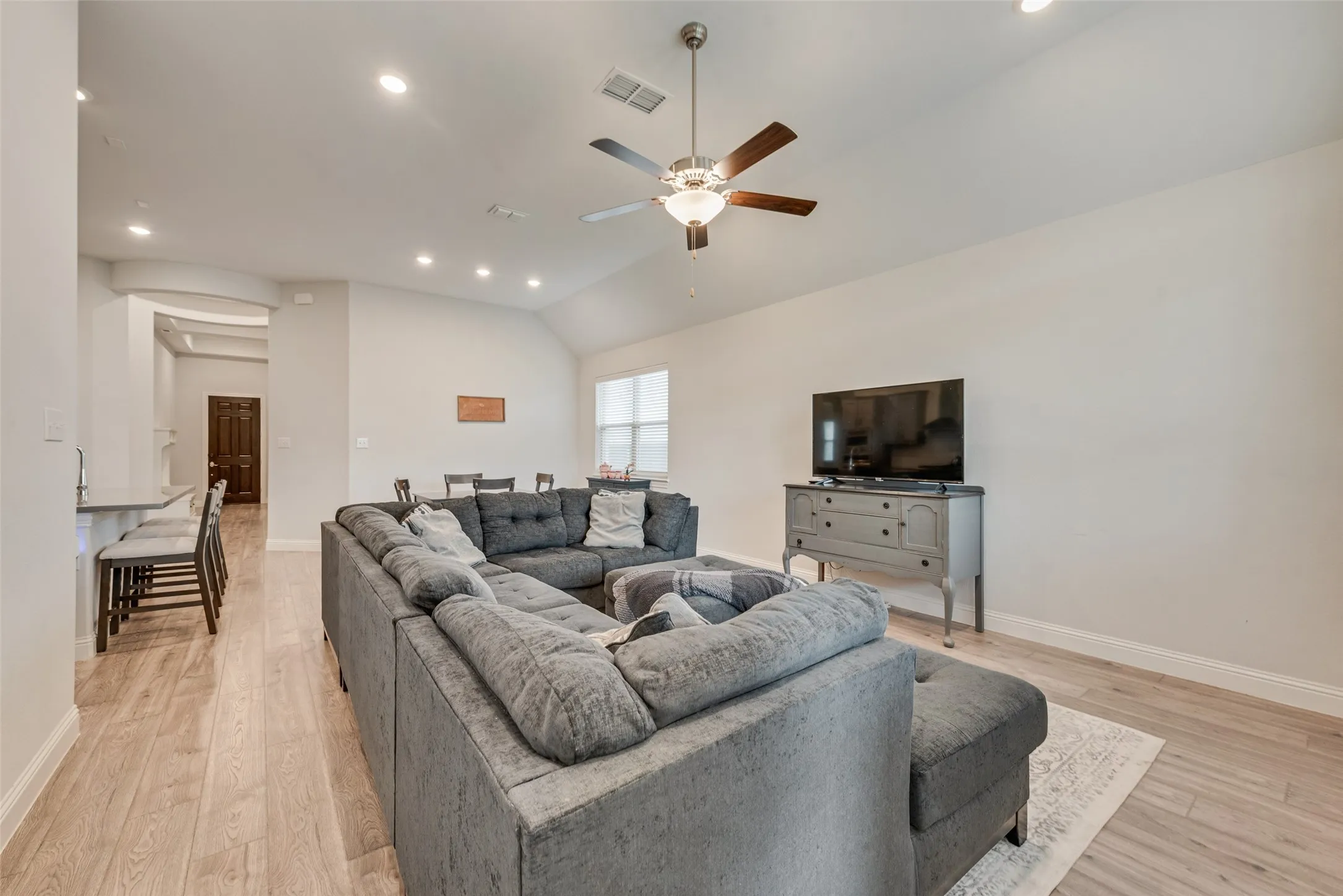 Living room with engineered hardwood floors and 11 ft ceilings at 1721 Pattenson Trl, Haslet, TX 76052 in Wellington subdivision