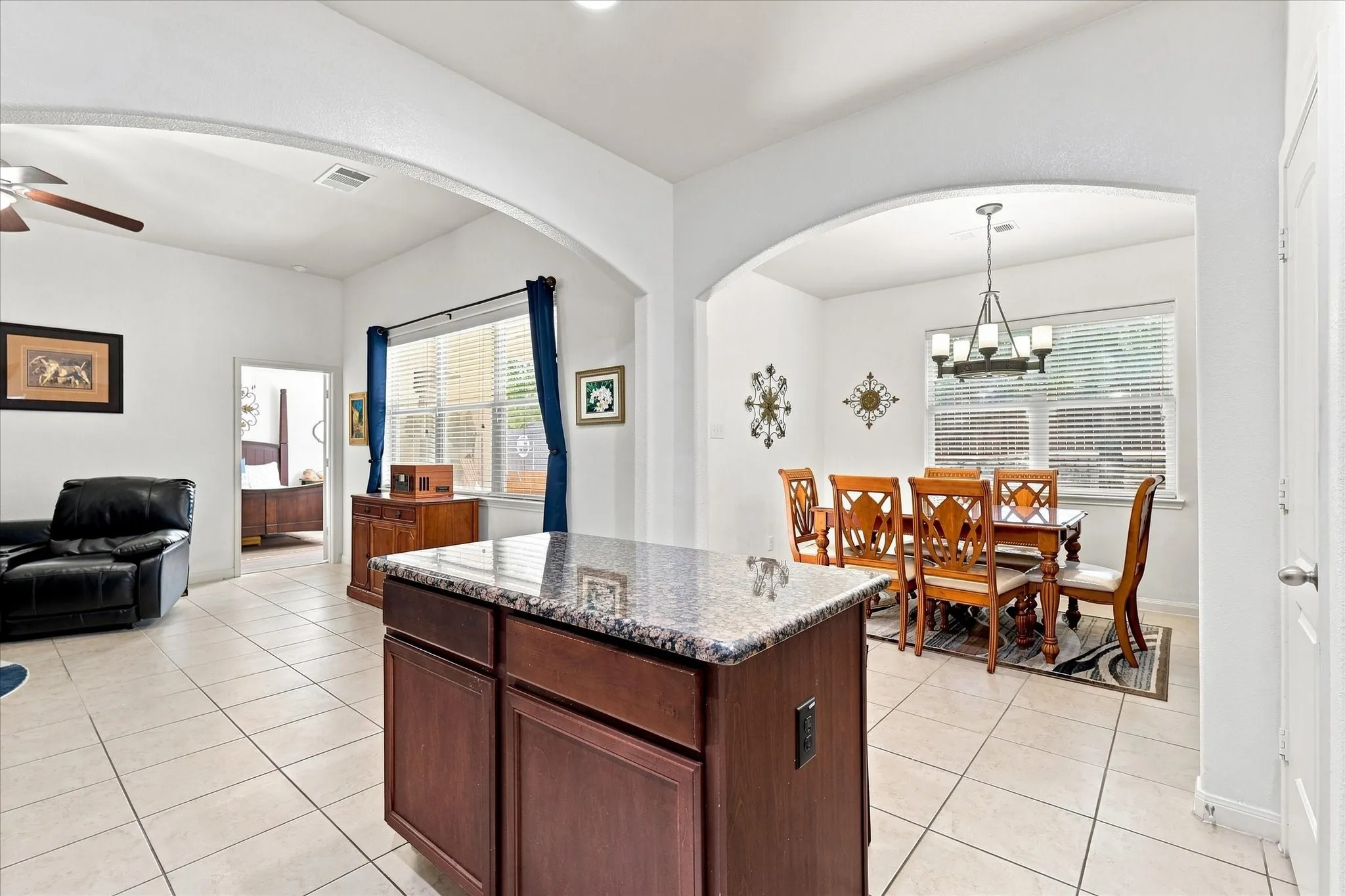 Kitchen island with granite countertops, open to living and dining. Easy access to  back patio making it a breeze for your morning coffee and grilling.