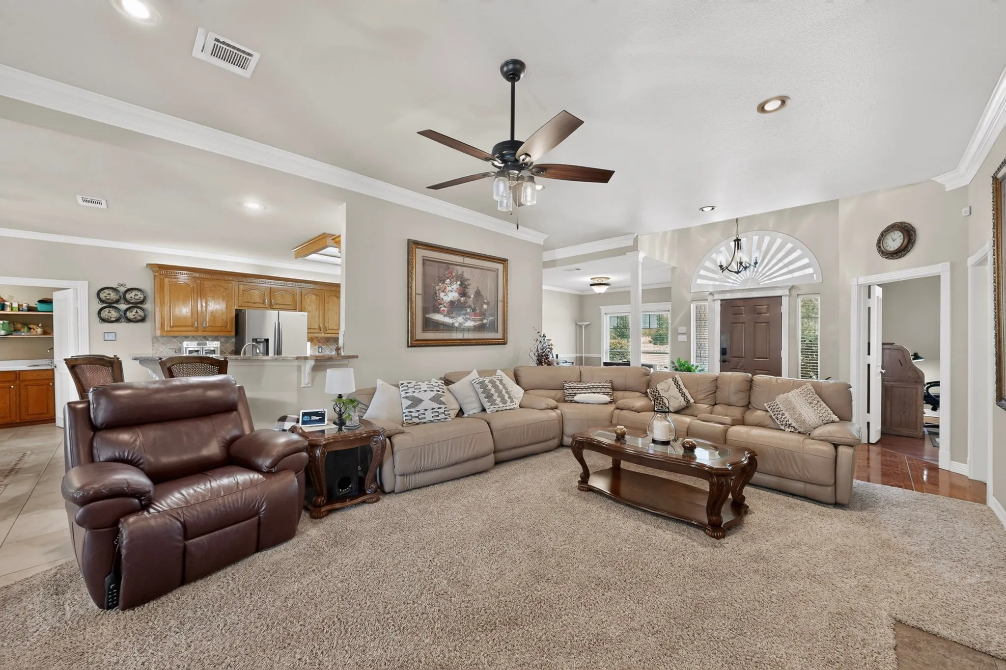 Spacious living area with recessed lighting, crown molding, a ceiling fan, and carpeted flooring