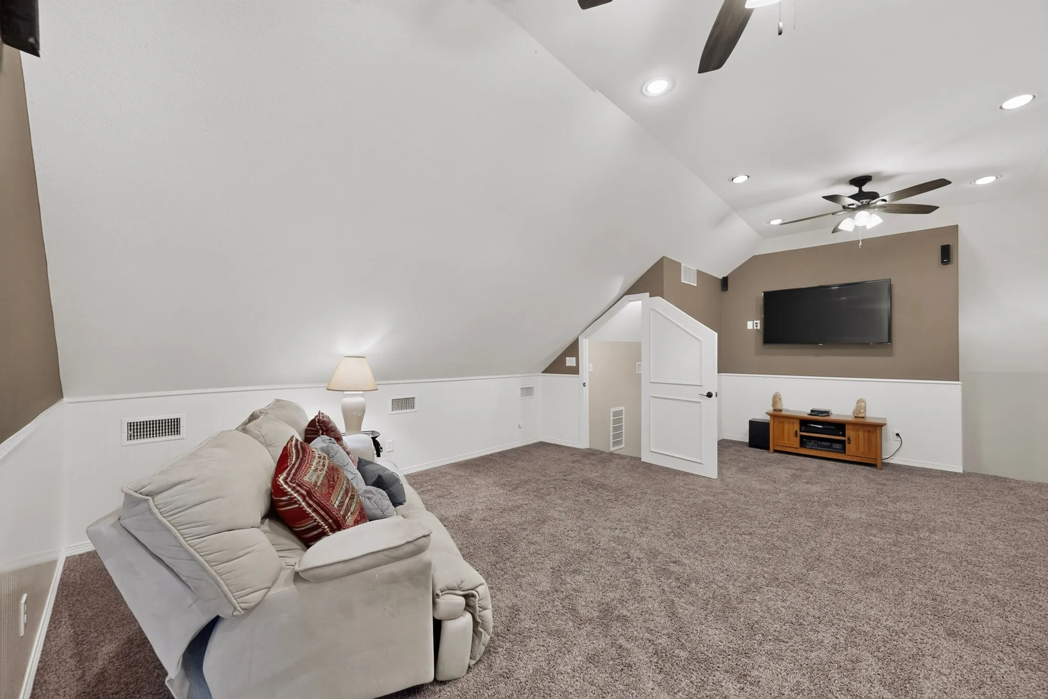 Vaulted ceilings with recessed lighting, ceiling fan, carpeted flooring, and built-in wall speakers