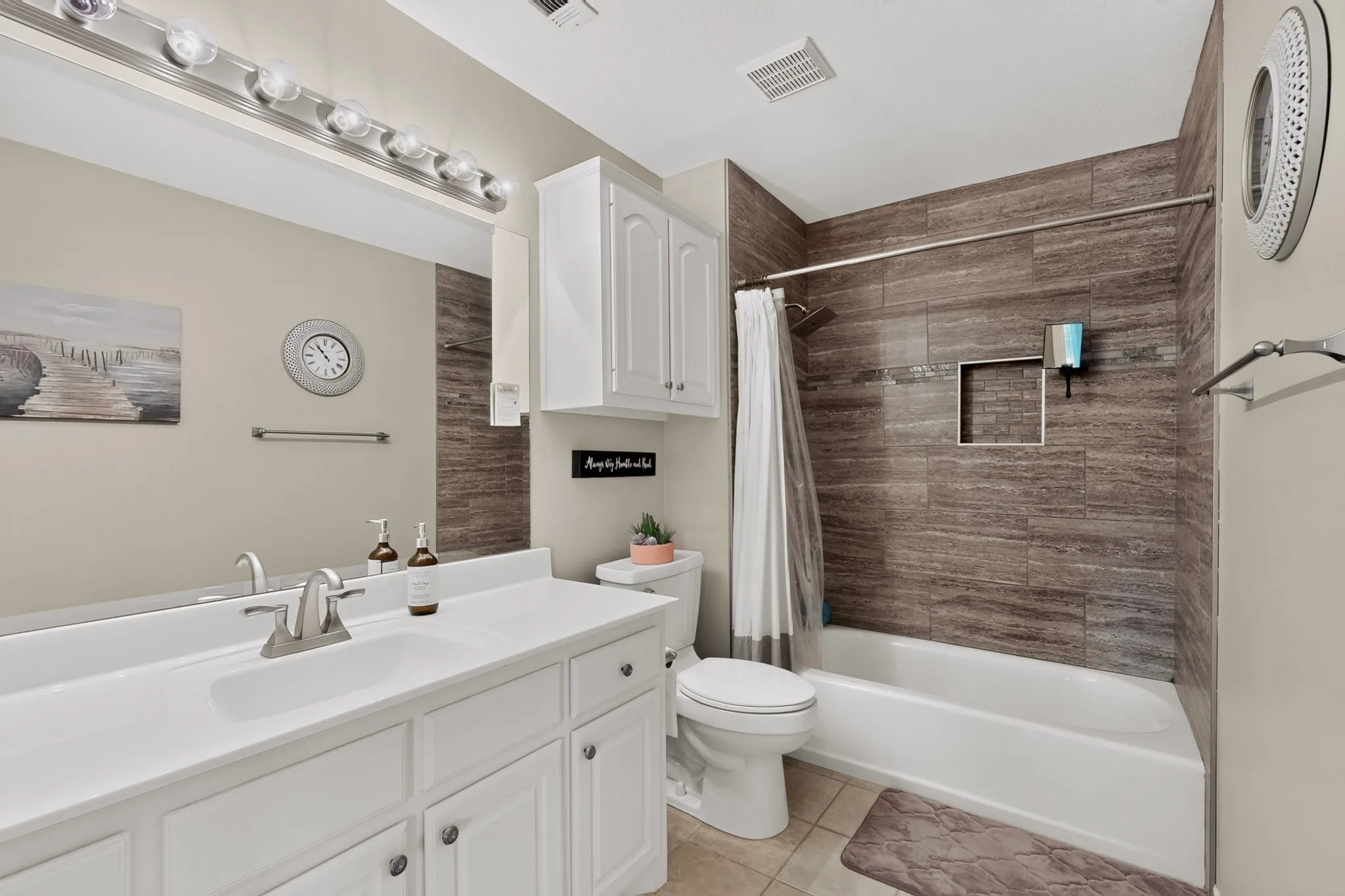Tub/shower combination with horizontal wood-finish tile surround and recessed niche