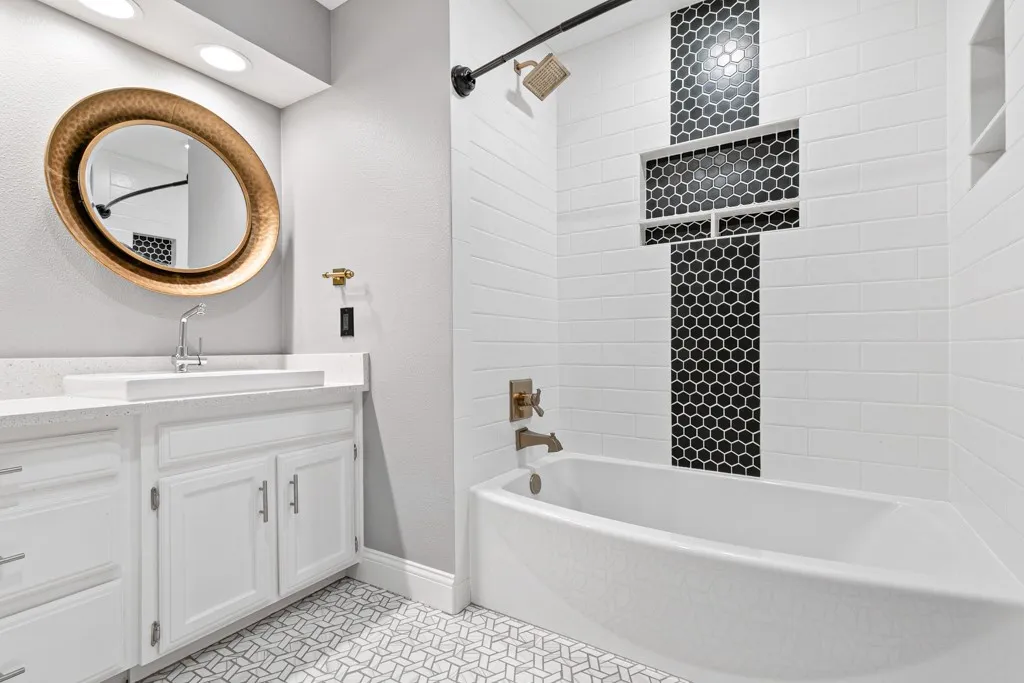 Bathroom featuring double vanity, shower / bath combination, and recessed lighting