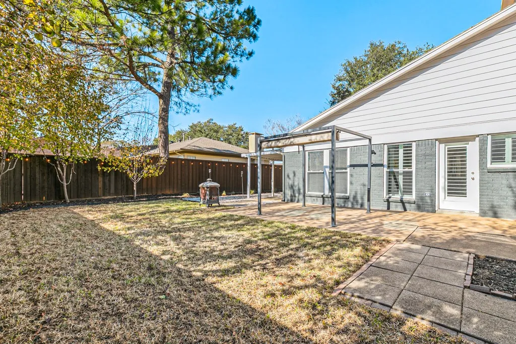 Private fenced-in backyard with a patio