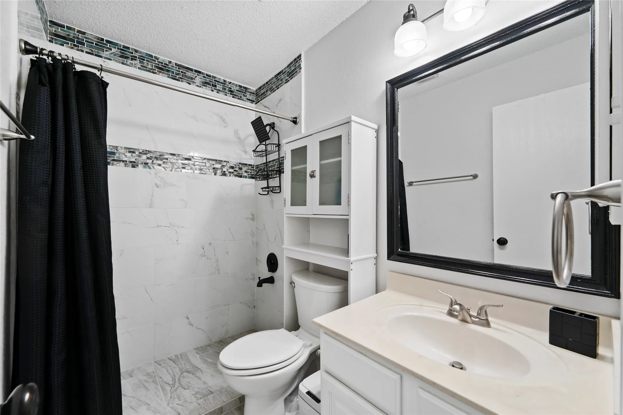 White vanity with an integrated sink and brushed nickel faucet
